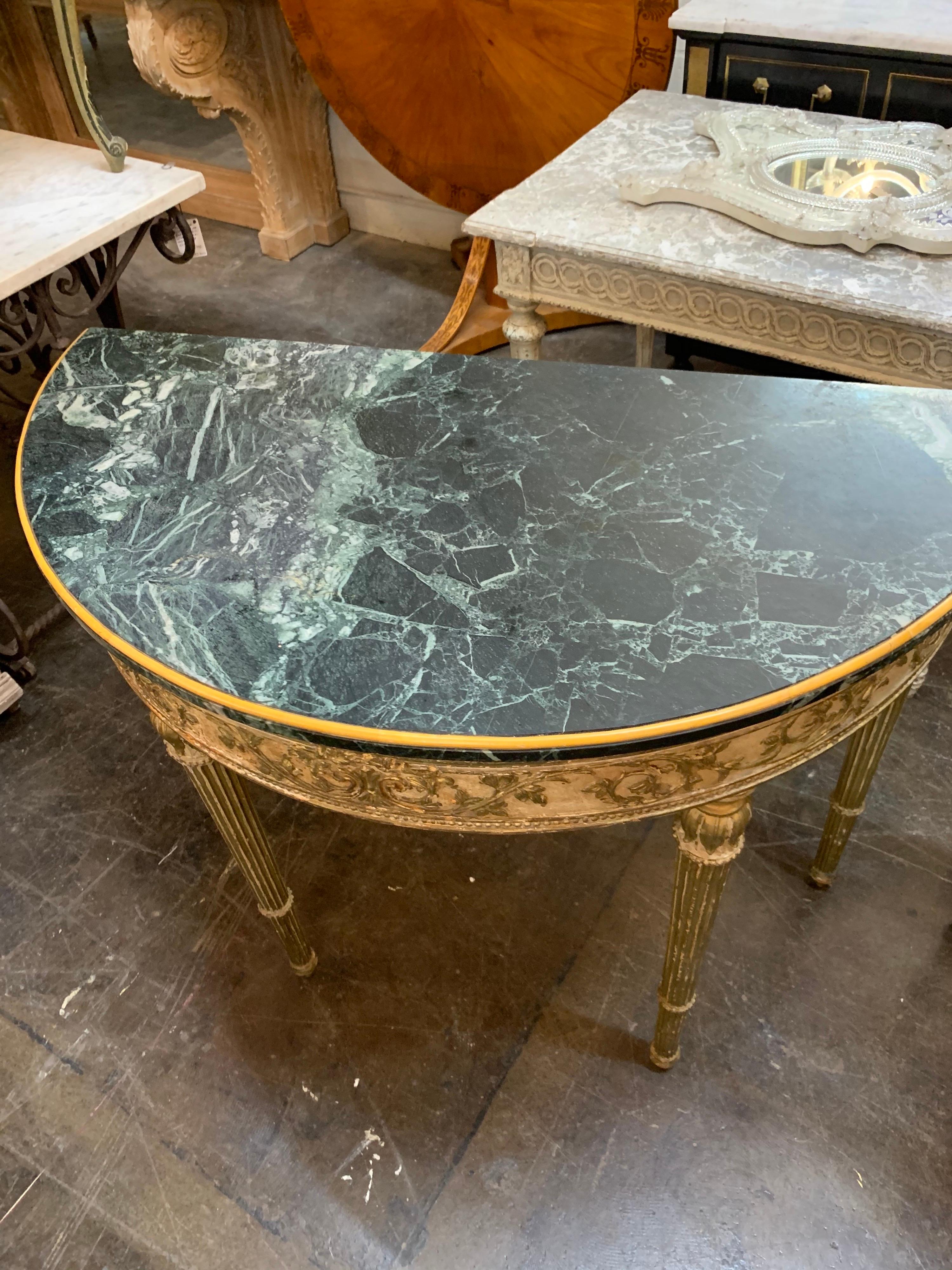 Superb pair of 19th century French Louis XVI style parcel-gilt demilune consoles.
Very fine carving and beautiful gilt on these and quality green marble top as well. A truly exquisite pair!