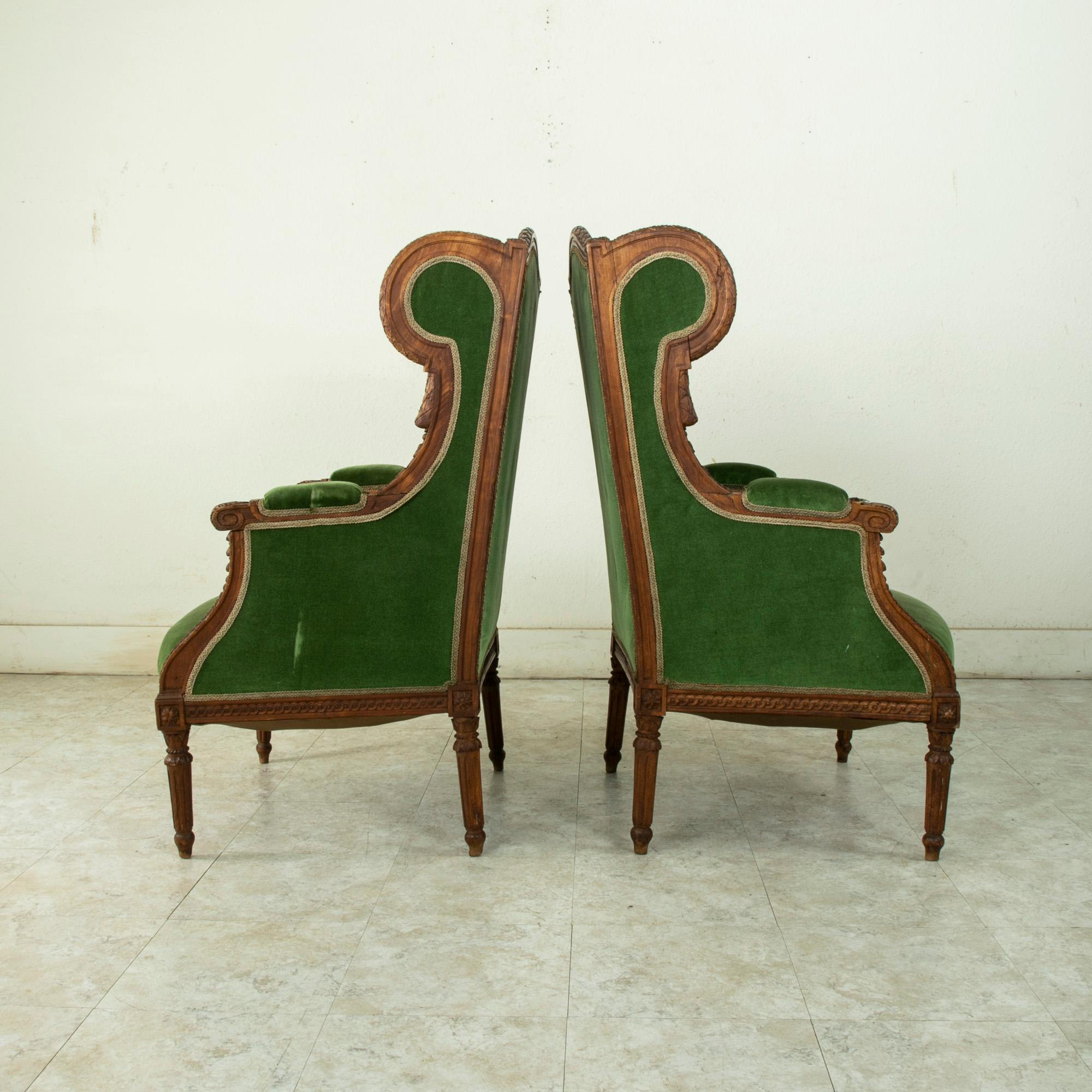 Hand-Carved Pair of 19th Century French Louis XVI Style Walnut Wingback Armchairs, Bergeres