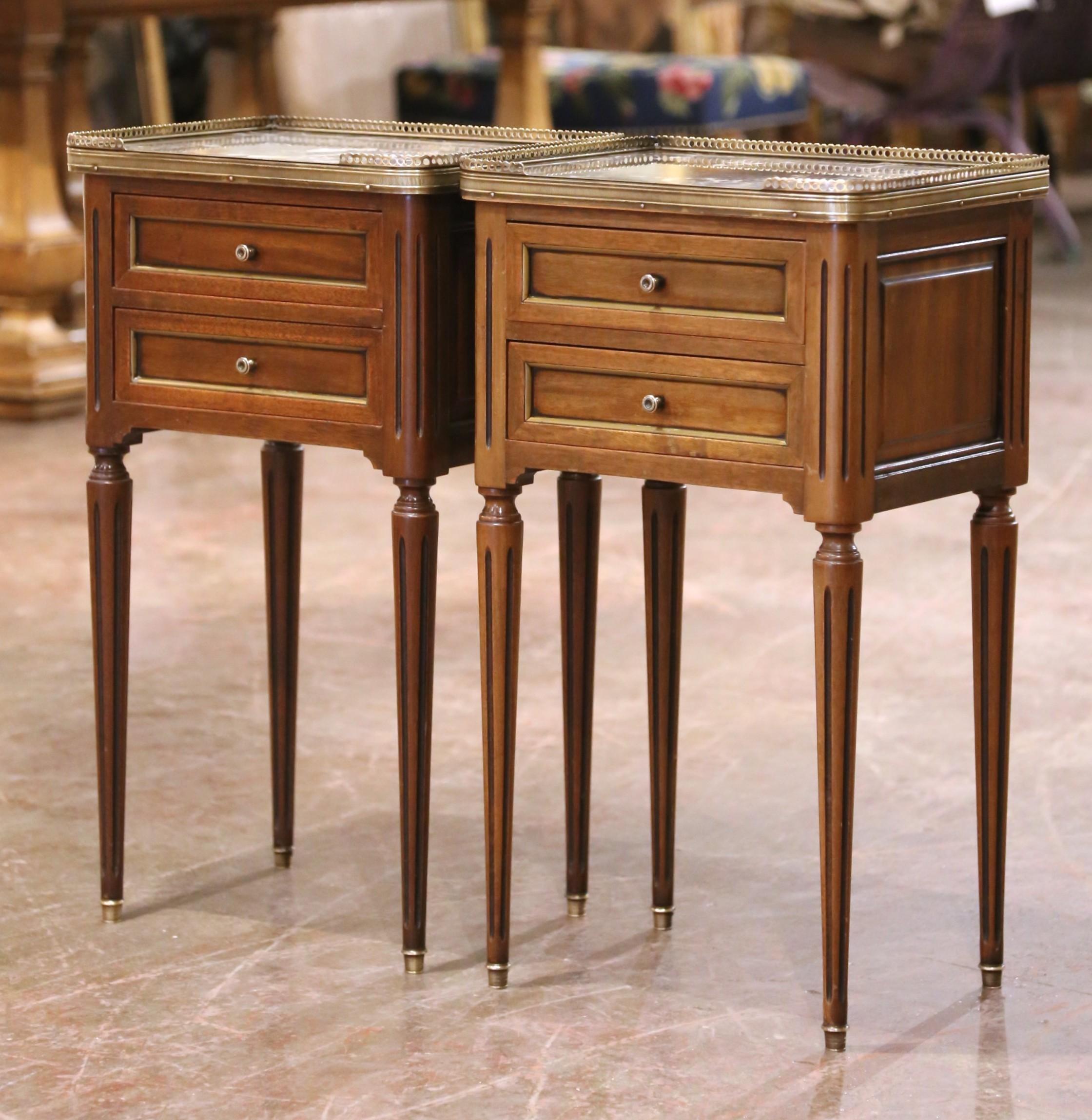 Crafted in Paris, France circa 1880, this elegant pair of Louis XVI style nightstands embodies the refined symmetry and classical detailing of late 19th-century neoclassical furniture. Each table is built from walnut and features clean rectangular