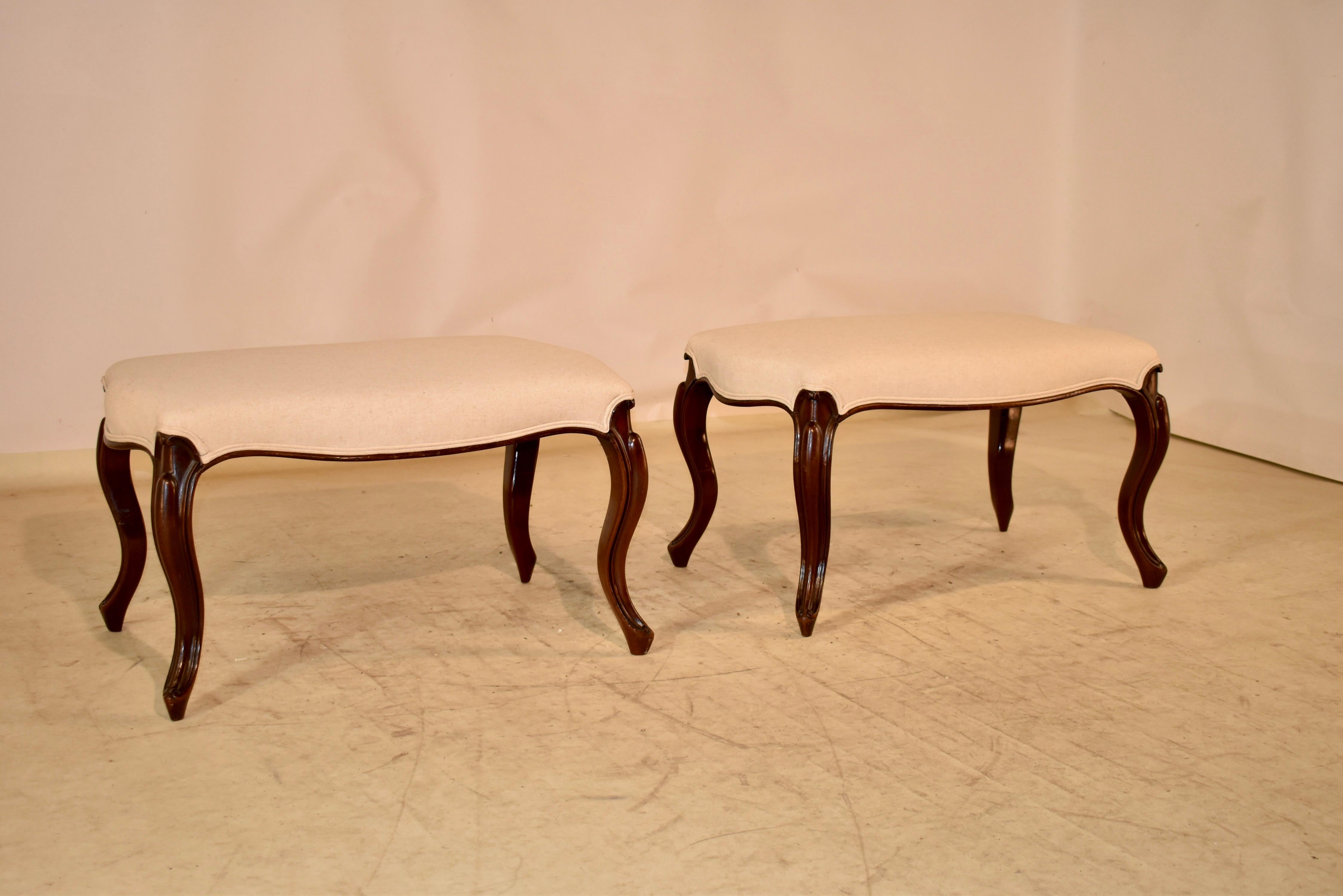 19th century pair of fabulous French benches in mahogany.  The seats are turtle shaped, with scalloping on all four sides.  The benches are supported on  cabriole legs with carved decorated knees, and lovely scalloped shaped aprons. They have been