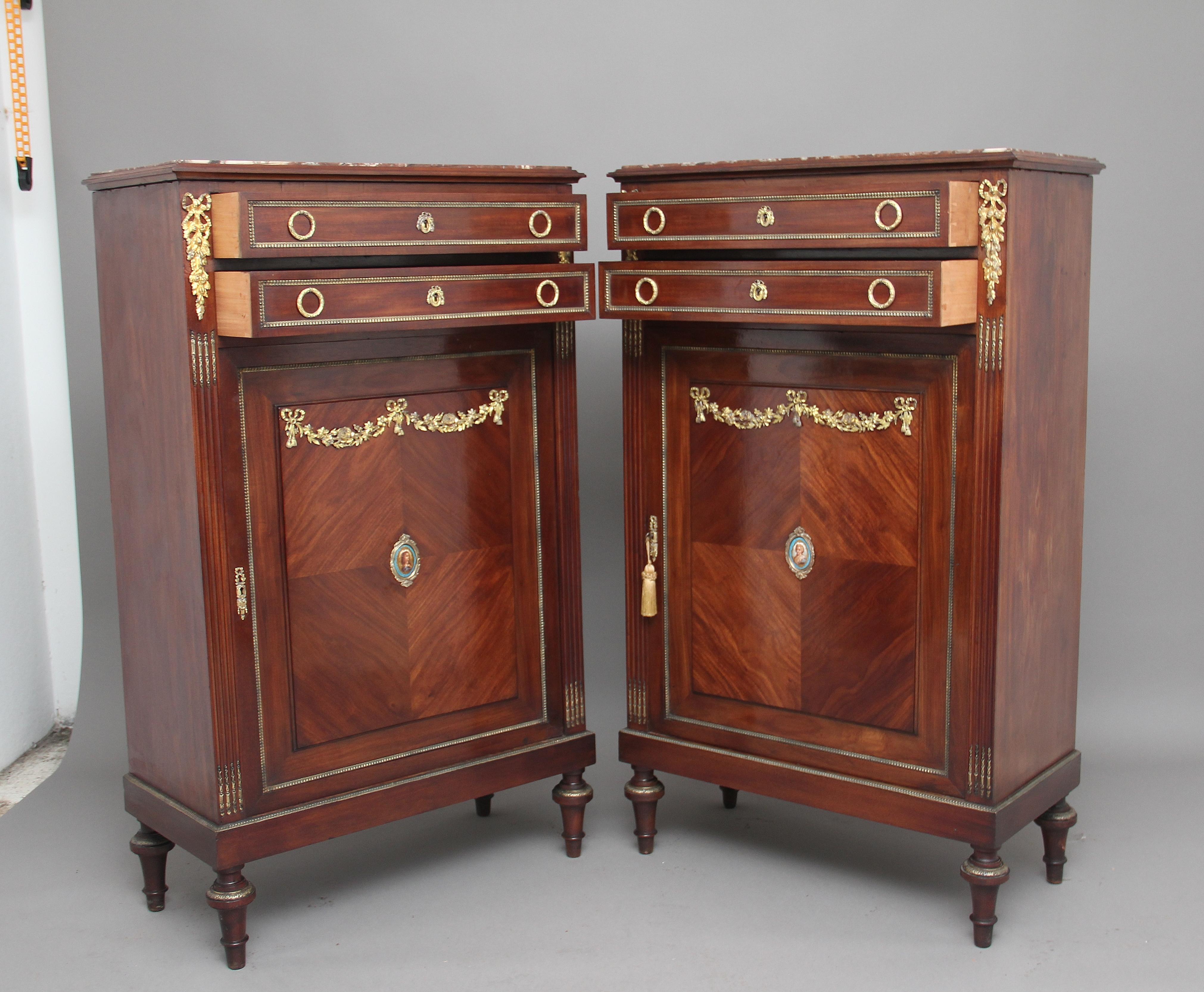 A pair of mid-19th century French mahogany side cabinets with ormolu mounts and mouldings, the tops having a nice moulded edge inset with rouge marble, each cabinet having two mahogany lined drawers with original brass ring handles and escutcheons,