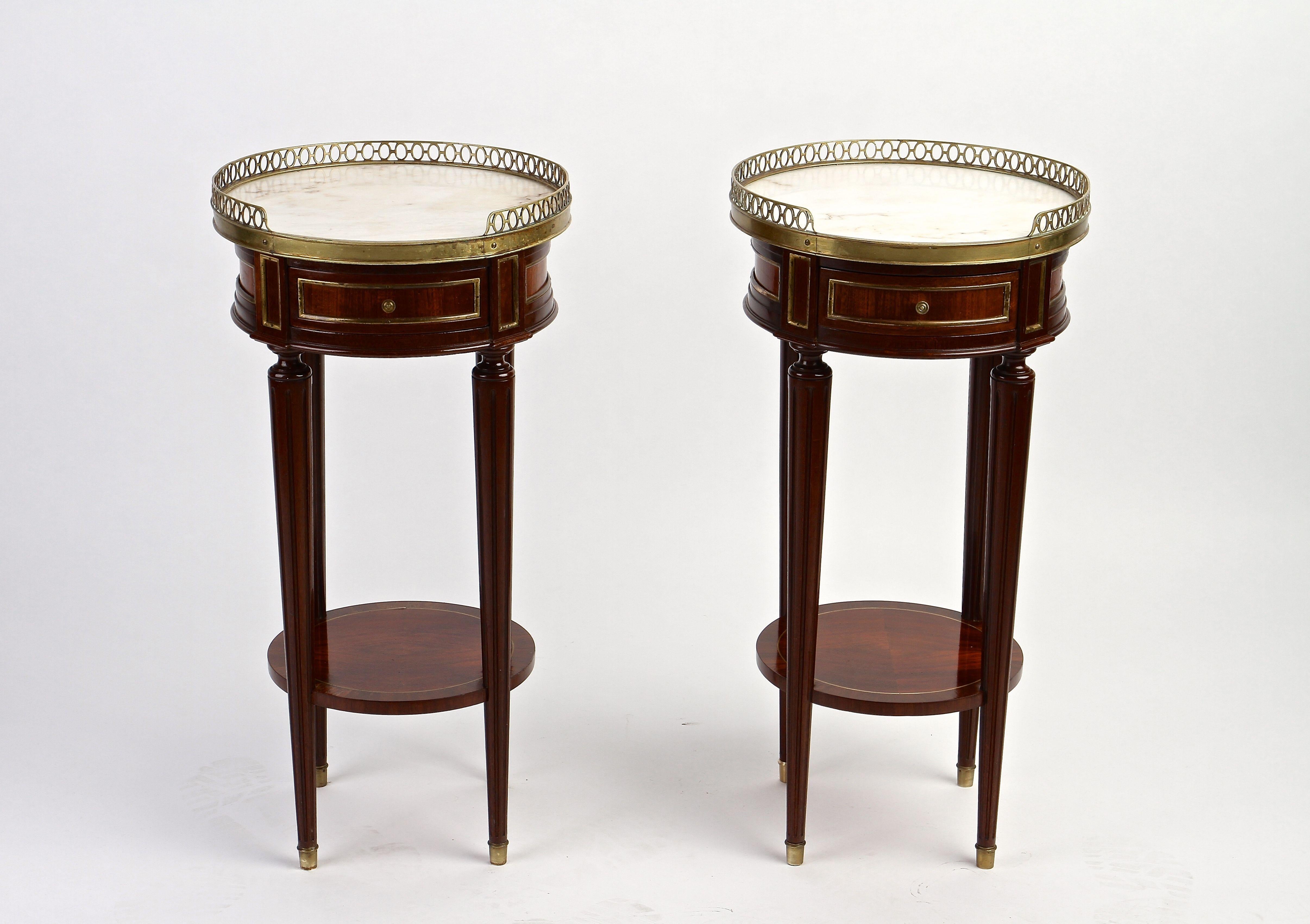 Gorgeous pair of 19th century French mahogany gueridon/ side tables from the period around 1870. Made of fine mahogany wood, these delicate round Gueridon tables show a very noble design. The lovely shaped round upper parts are adorned by slightly