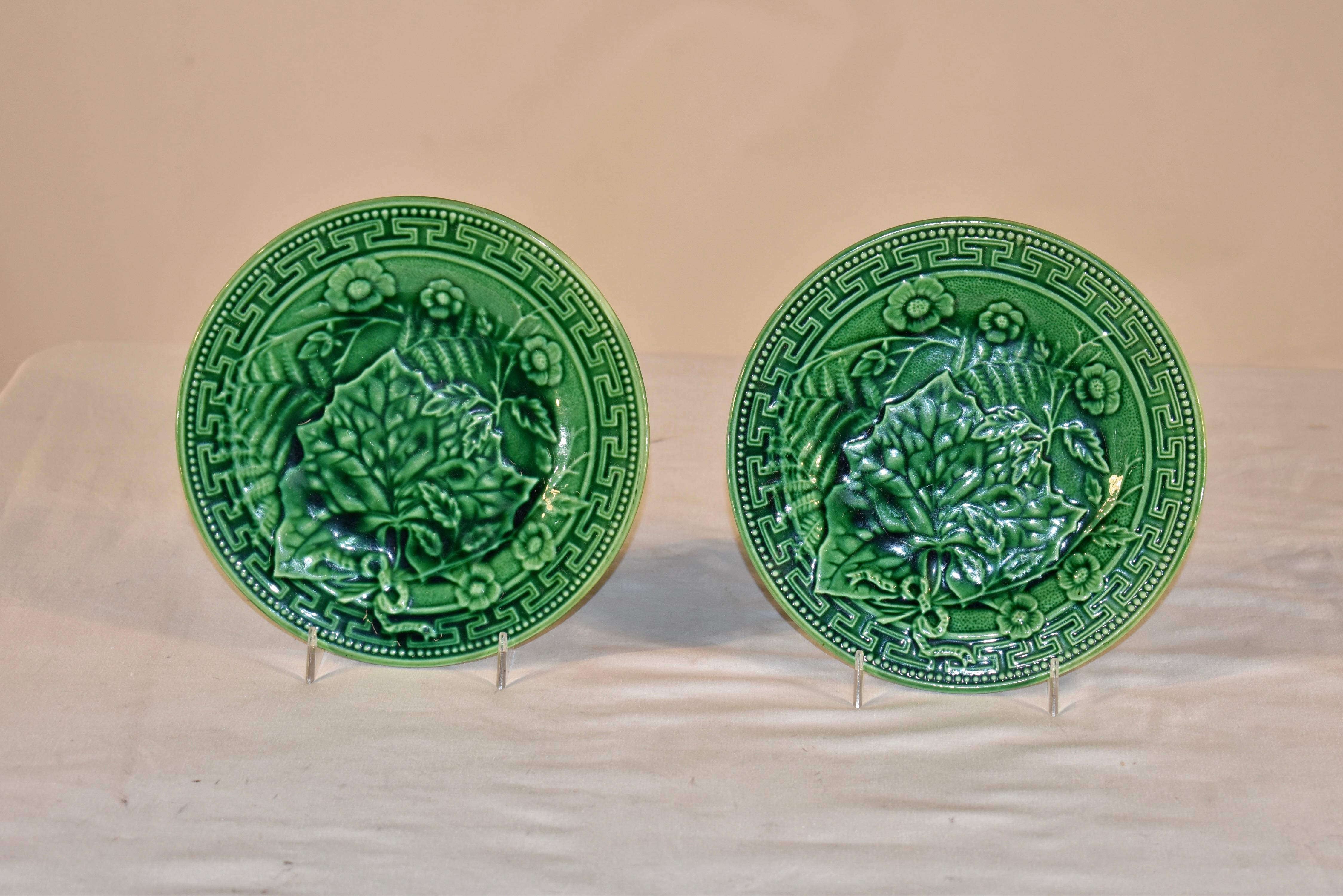 Pair of lovely 19th century green majolica plates with wonderful design detail.  The border is beaded and surrounds a Greek key design, all surrounding the center of the plate, which has a pattern of ferns, florals, and leaves.  This is a lovely