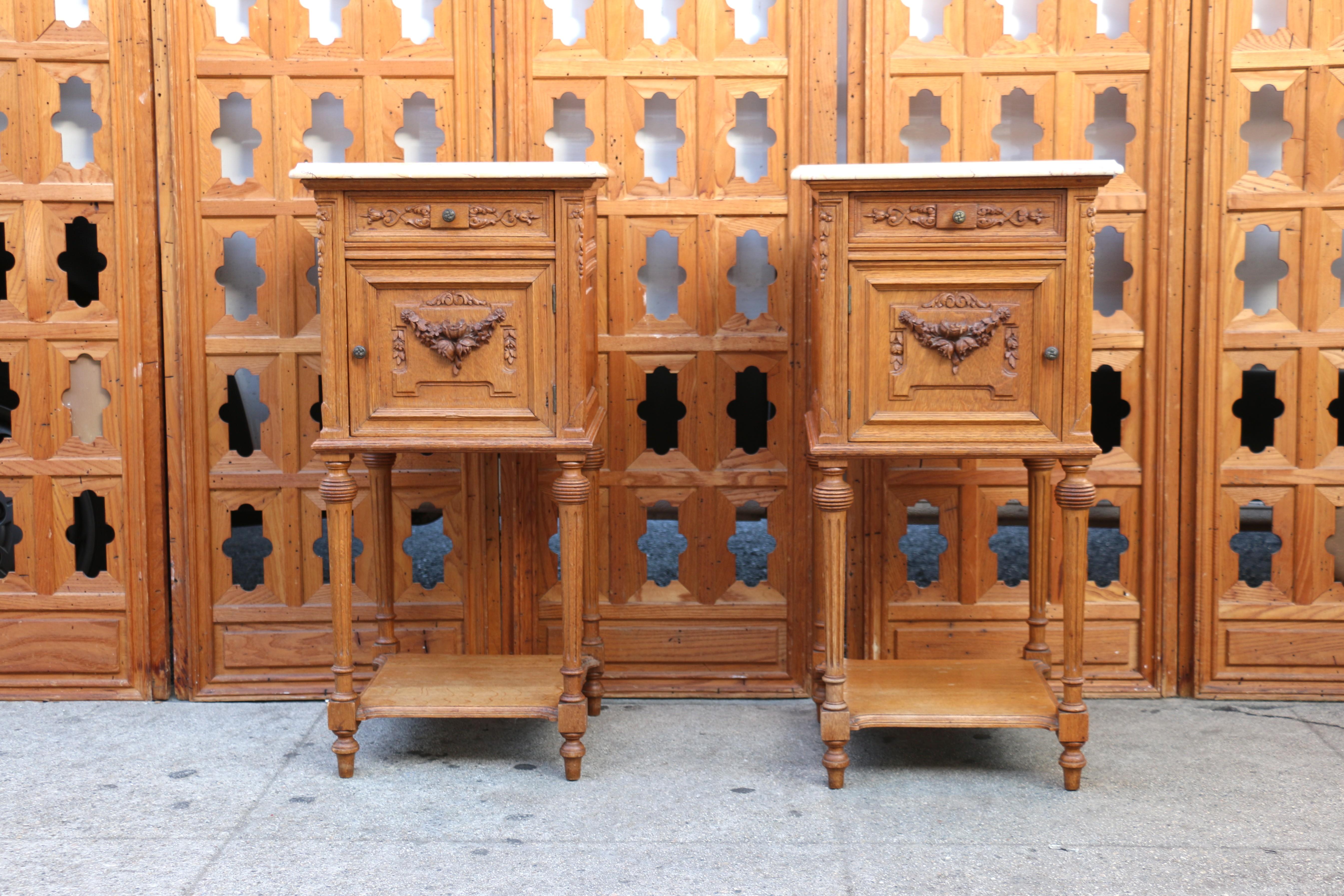 Wonderful pair of late 19th Century French nightstands. Just a great antique pieces are made of a honey-colored oak has a lovely marble top and porcelain. They have a single drawer that opens perfectly and a door that has the porcelain inside. The