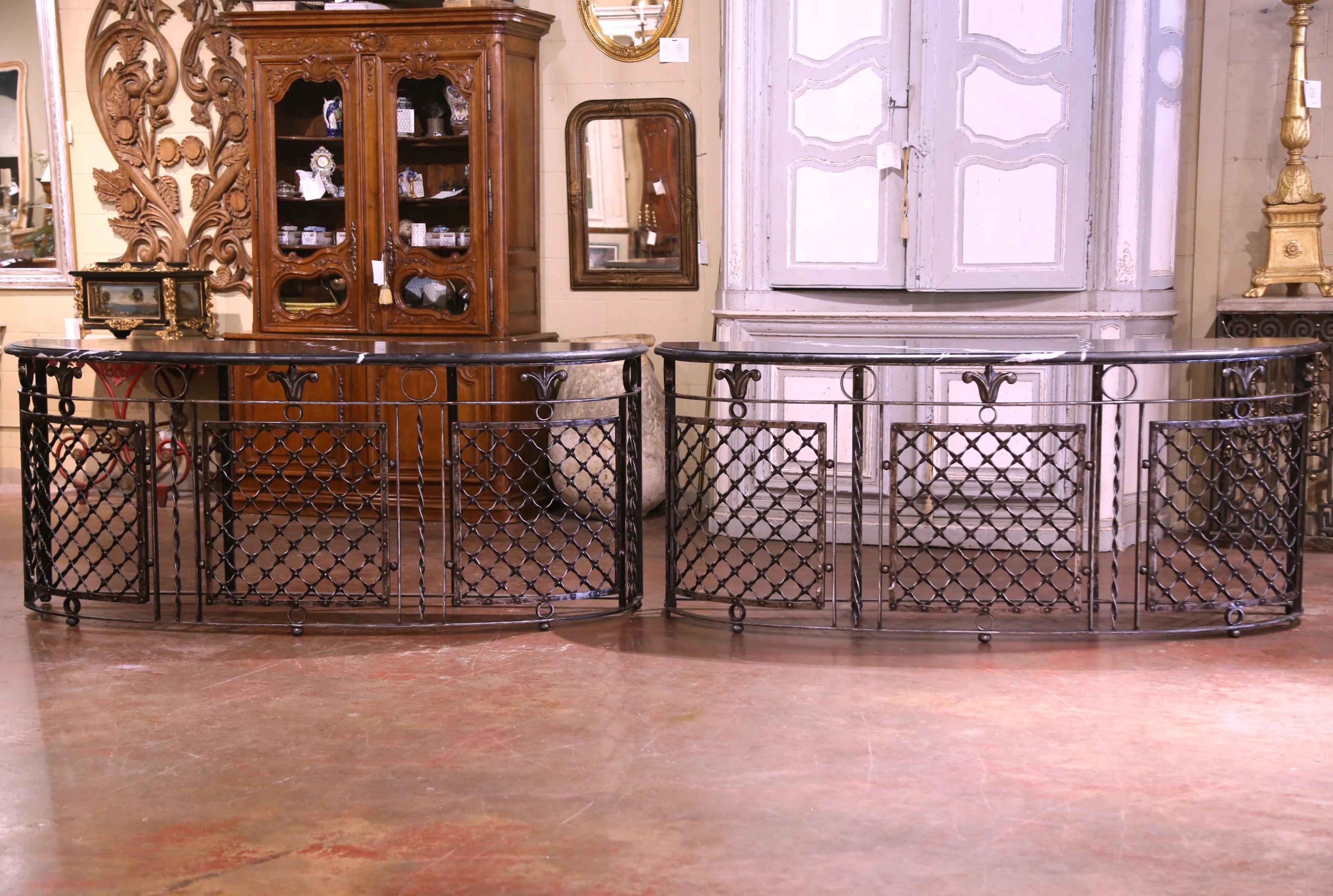 Decorate an entry or hallway with these exquisite elegant console tables built with antique railings. Forged in France circa 1880, the tall table bases stand on straight legs connected with an all around bottom stretcher. The consoles feature a
