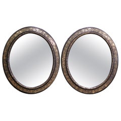 Pair of 19th Century French Napoleon III Black and Gold Oval Wall Mirrors