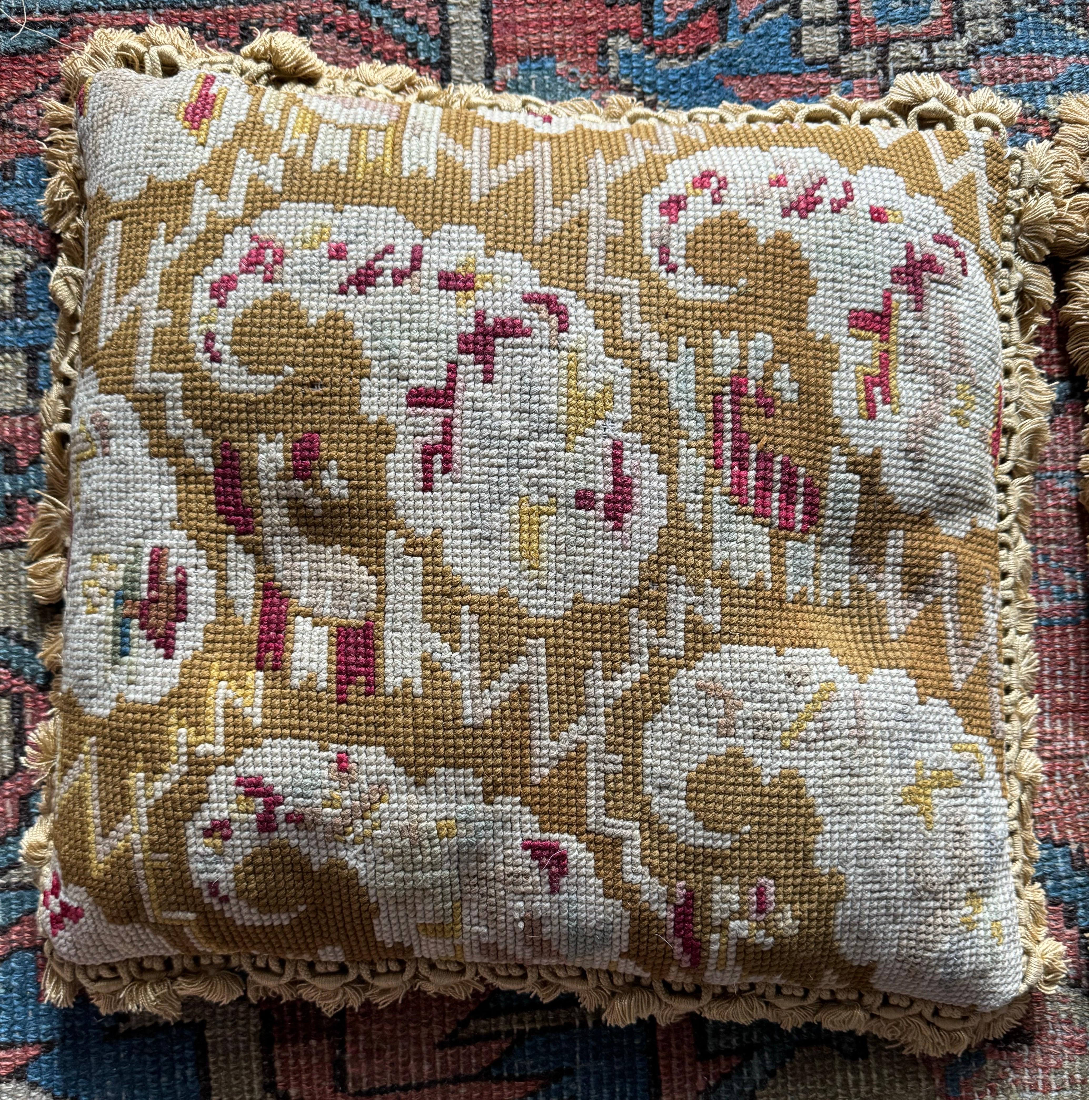 A pair of down filled French Provincial Needlepoint pillows from the 19th century with  petite tassels that will brighten up any sofa, canapé or settee! 

They are in very good condition and each measure approximately 16 x 17 inches.

Complimentary