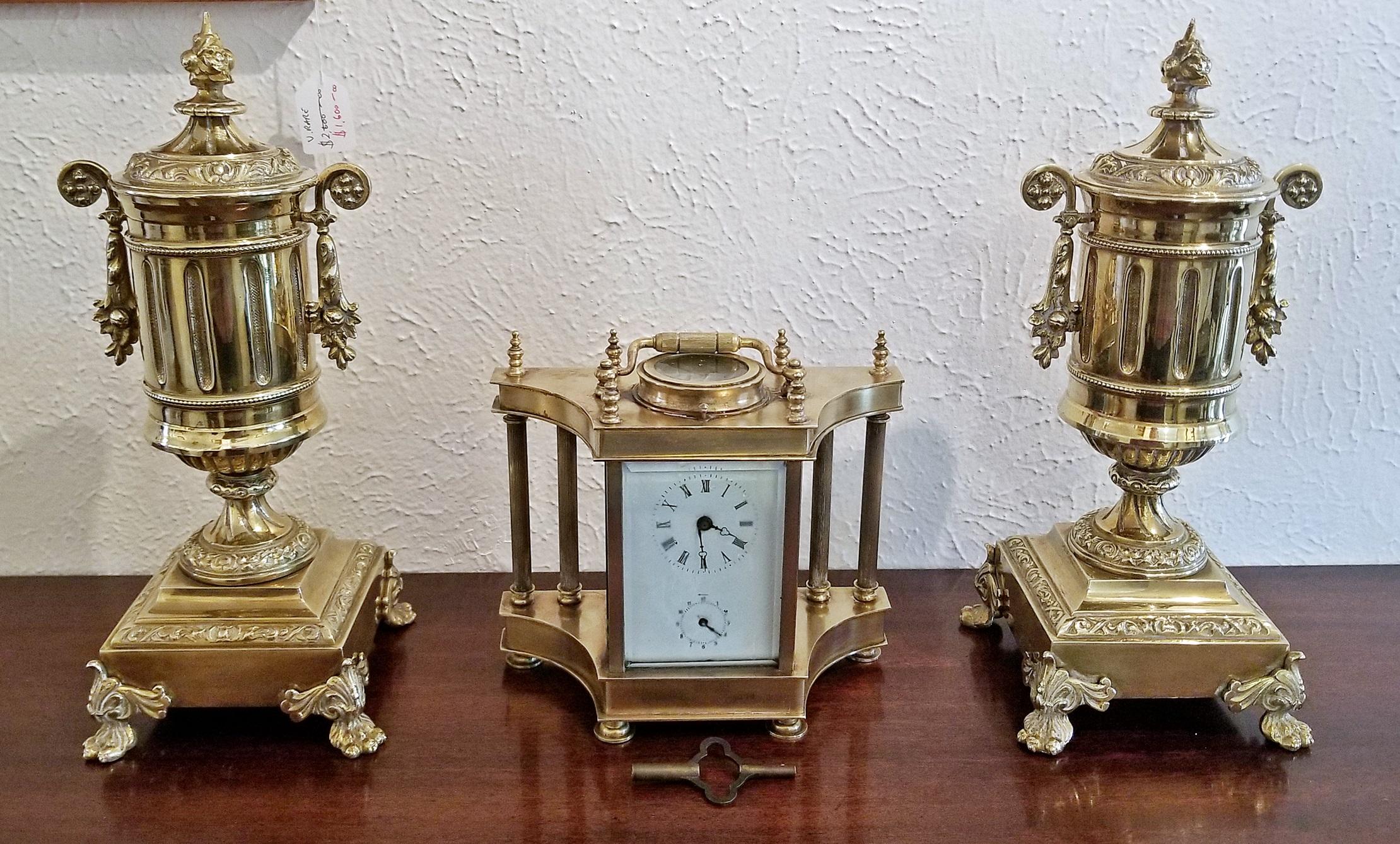 Really nice pair of solid brass garnitures in the shape of urns.

Pointed finial on top, with a fluted and tapered body and side handles leading to a plinth with lions paw supports.

French Empire or neoclassical style.

Perfect accompaniment