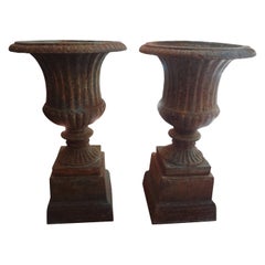 Pair of 19th Century French Neoclassical Style Iron Urns on Plinths
