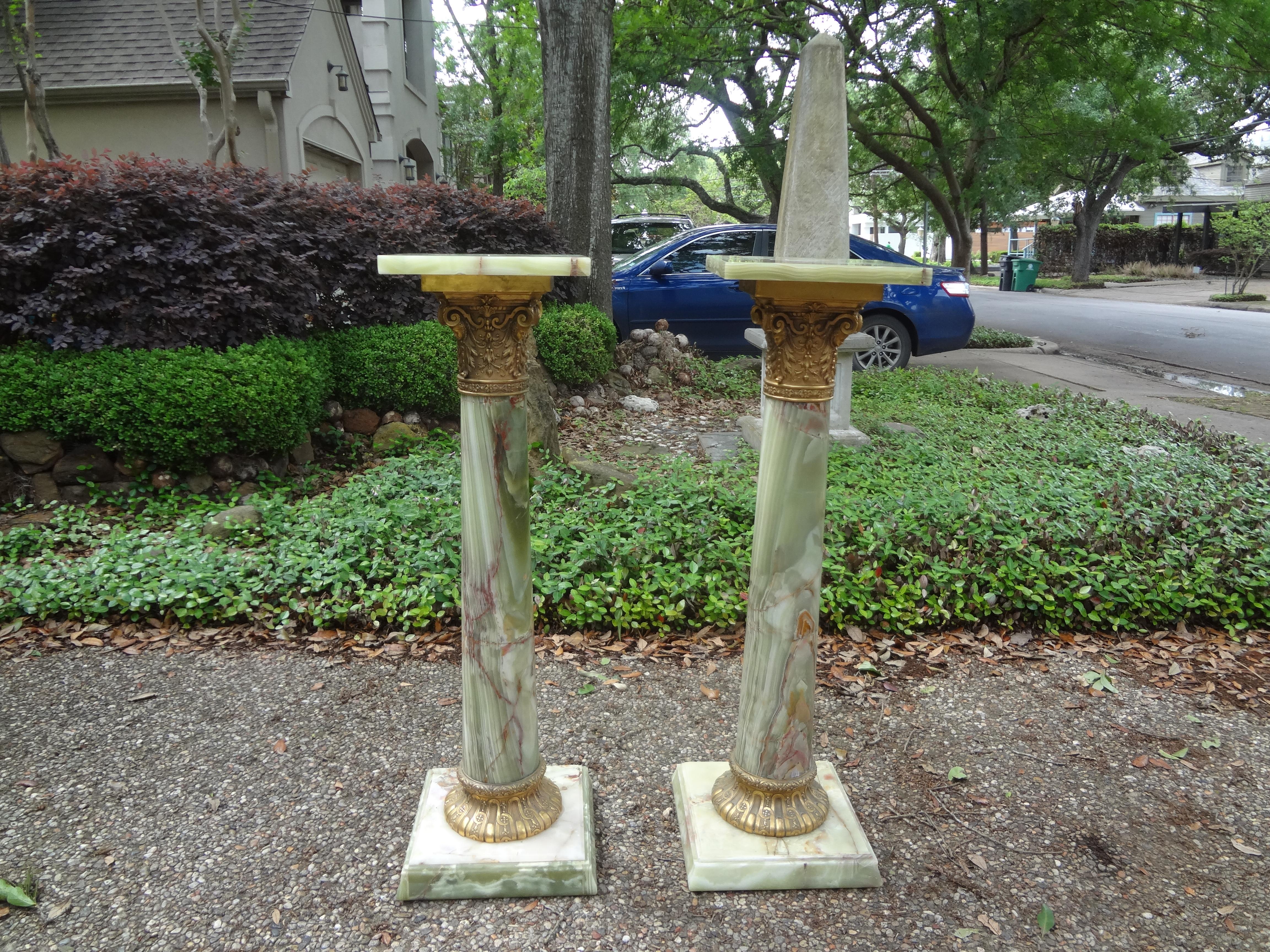 Stunning pair of 19th century French neoclassical style onyx and bronze pedestals. These fantastic antique French pedestals are
Made from green slab onyx in the form of stylized columns with Corinthian capitals. These pedestals have a large square