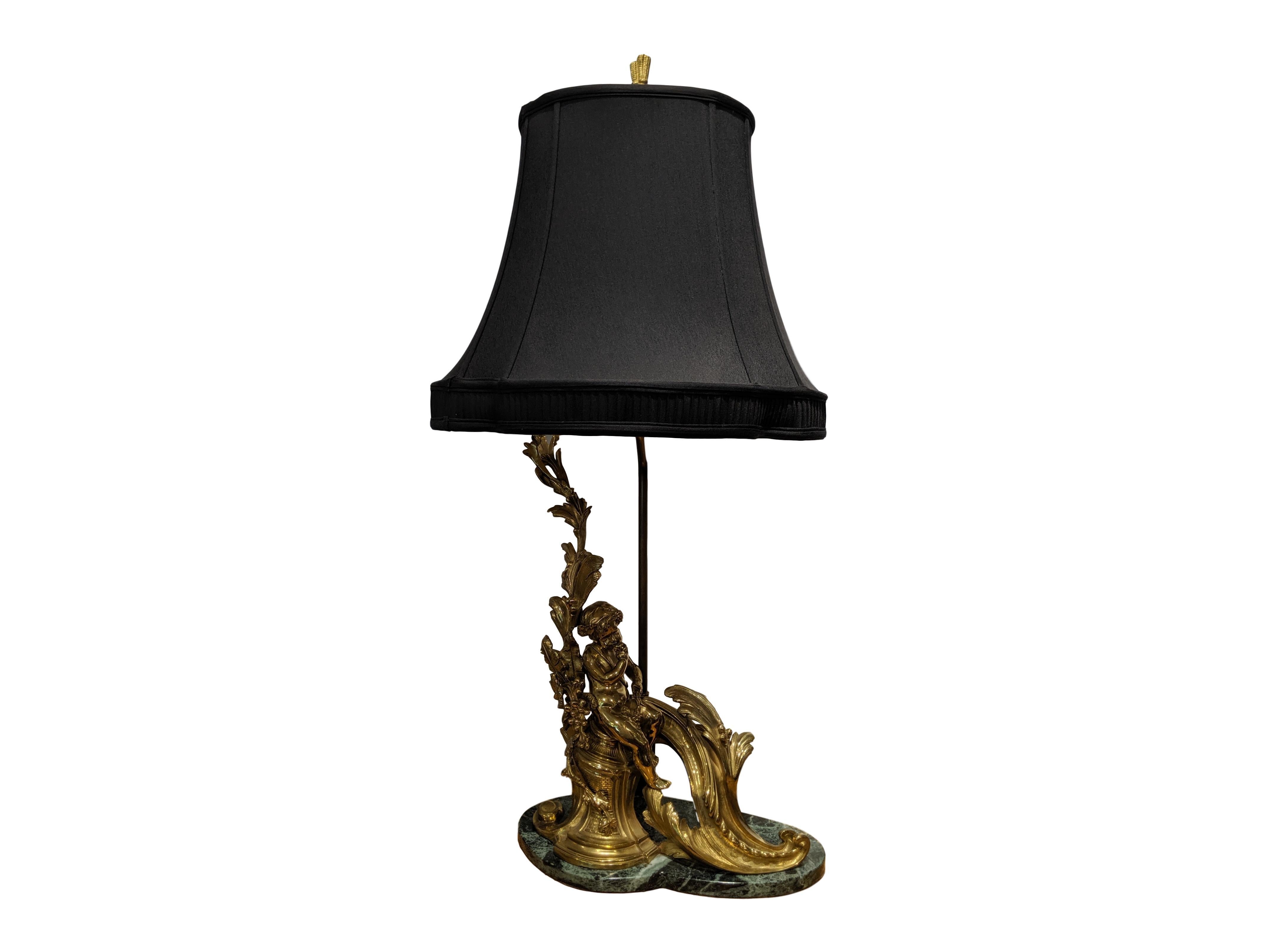 Stunning high quality pair of 19th Century French ormolu cherub like Chenet lamps mounted on marble with black pagoda shaped shades.