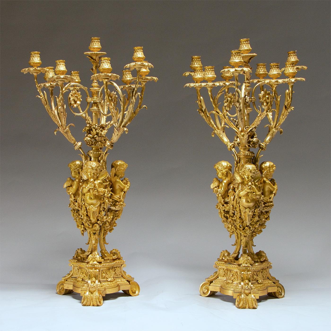 An important pair of French ormolu ten-light candelabra
cast by henry Picard, Paris, third quarter of the 19th century.
Each modeled with three cherub monopodia, holding doves and joined by floral garlands, supporting an Amphora with floral finial