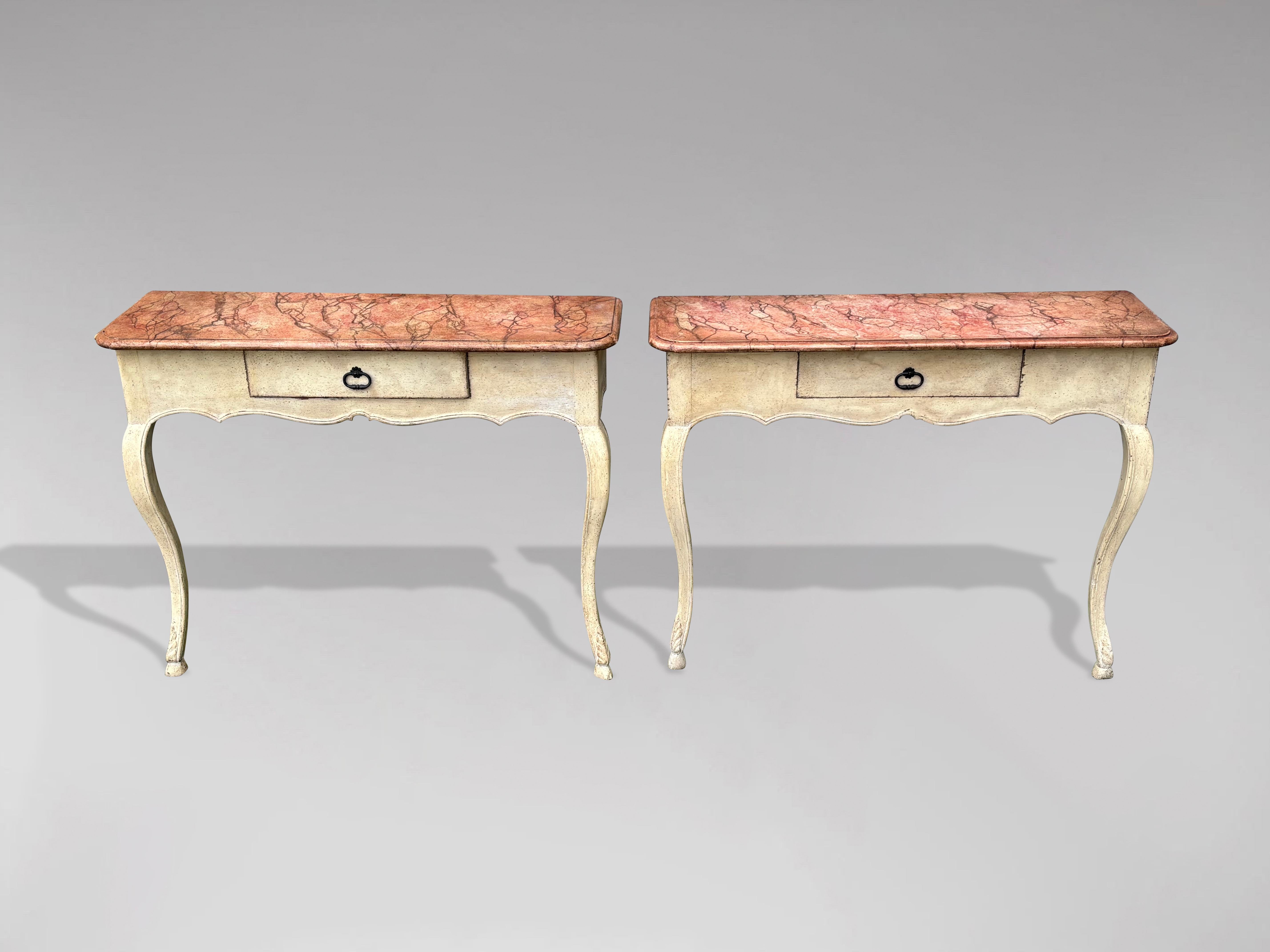 An elegant pair of 19th century French painted console tables with rectangular shaped painted faux marble tops, above a small central drawer with handle, a lovely shaped apron, all standing on a pair of gentle curved legs. Great colour with good