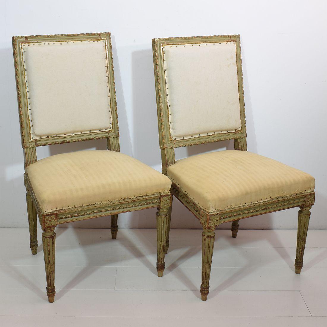 Stunning pair of Louis XVI style side chairs with traces of their original color . France, circa 1850. Weathered, small losses and old repairs. One chair has been repaired, see 2 old screws at the backside. More photo's available on request.