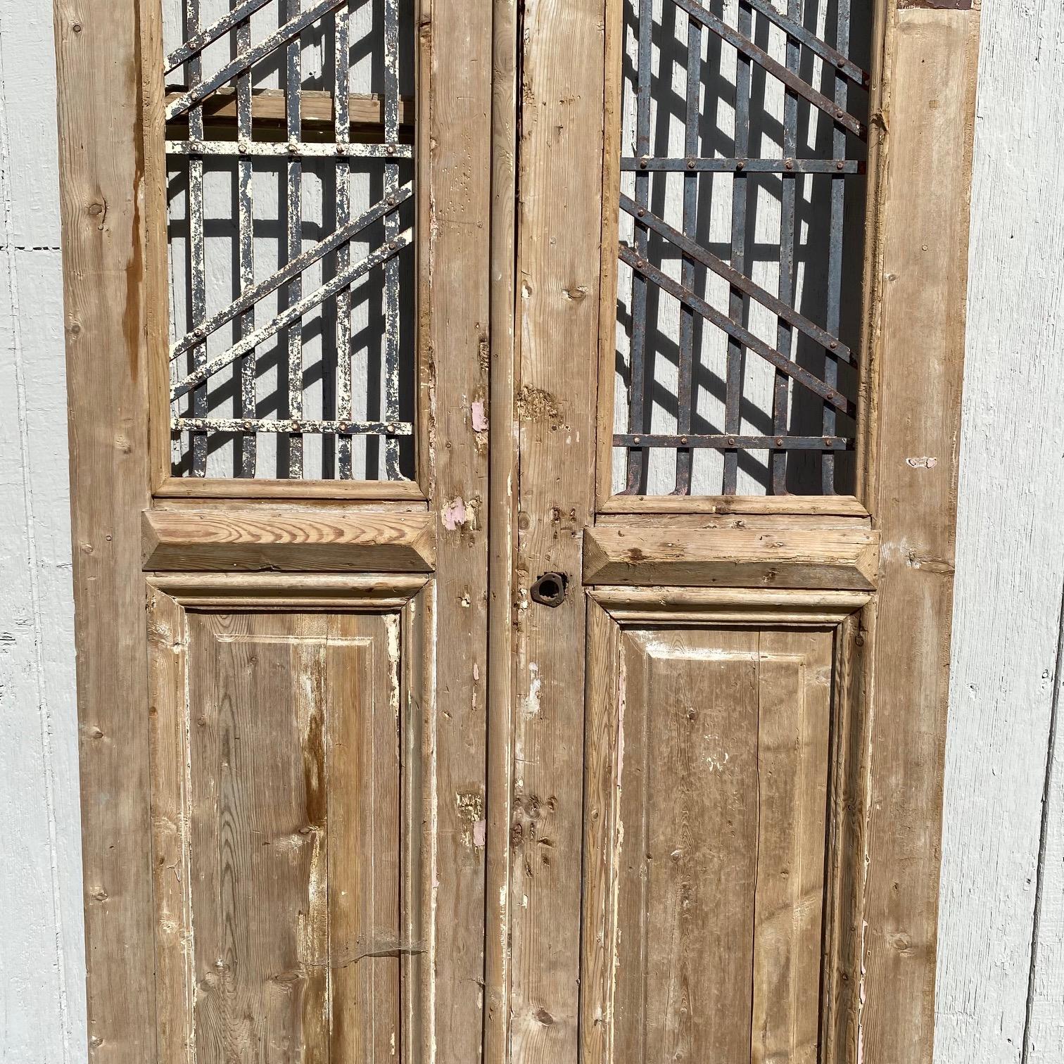 Pair of 19th Century French Paneled Doors with Intricate Wrought Iron Panels For Sale 3