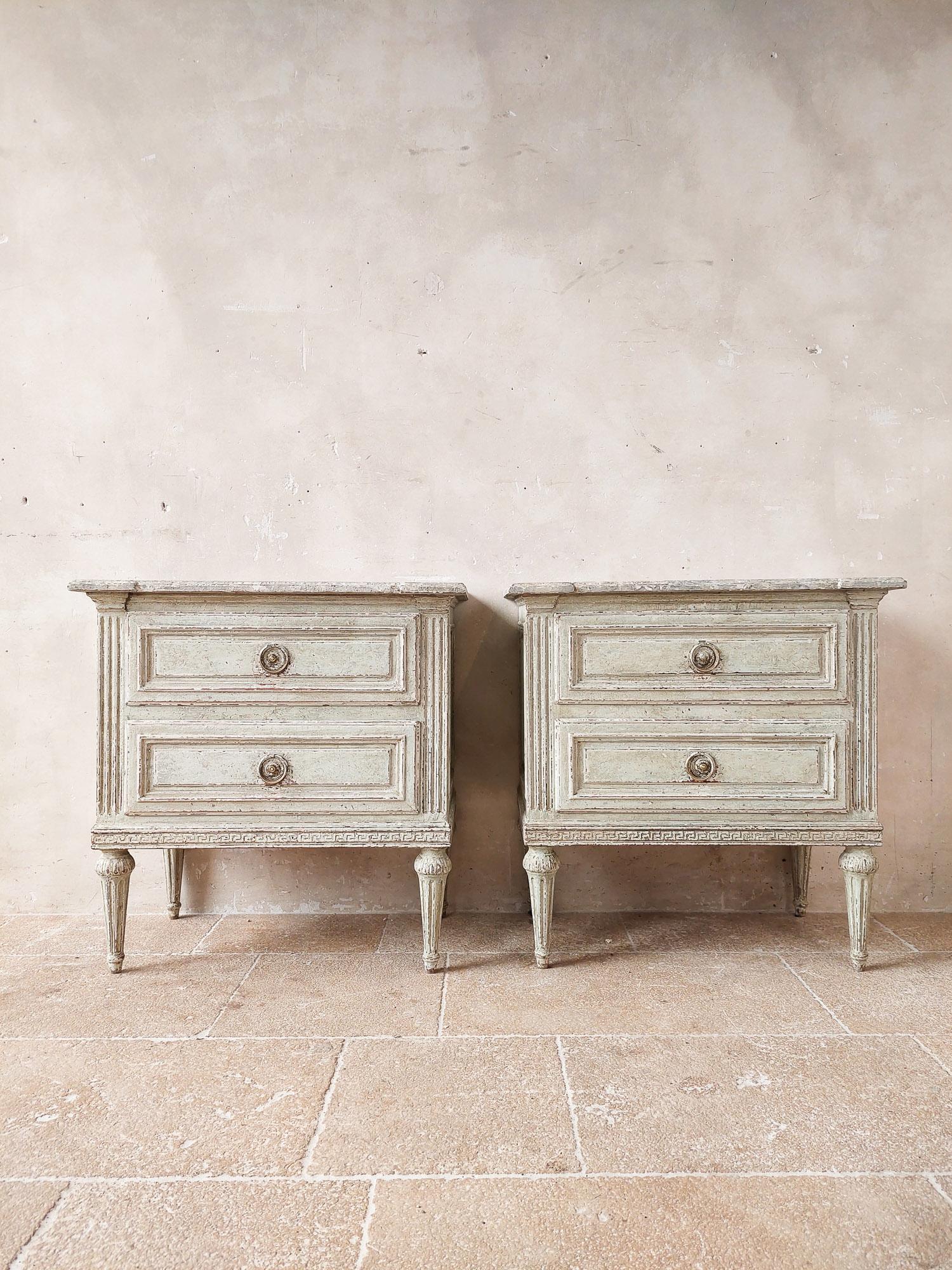 Pair of antique French large bedside tables from 19th century France. These beautiful drawers have an oakwood exterior that has been patinated in an aged grey and with the stunning details on the drawers and legs, these Louis XVI style commodes will