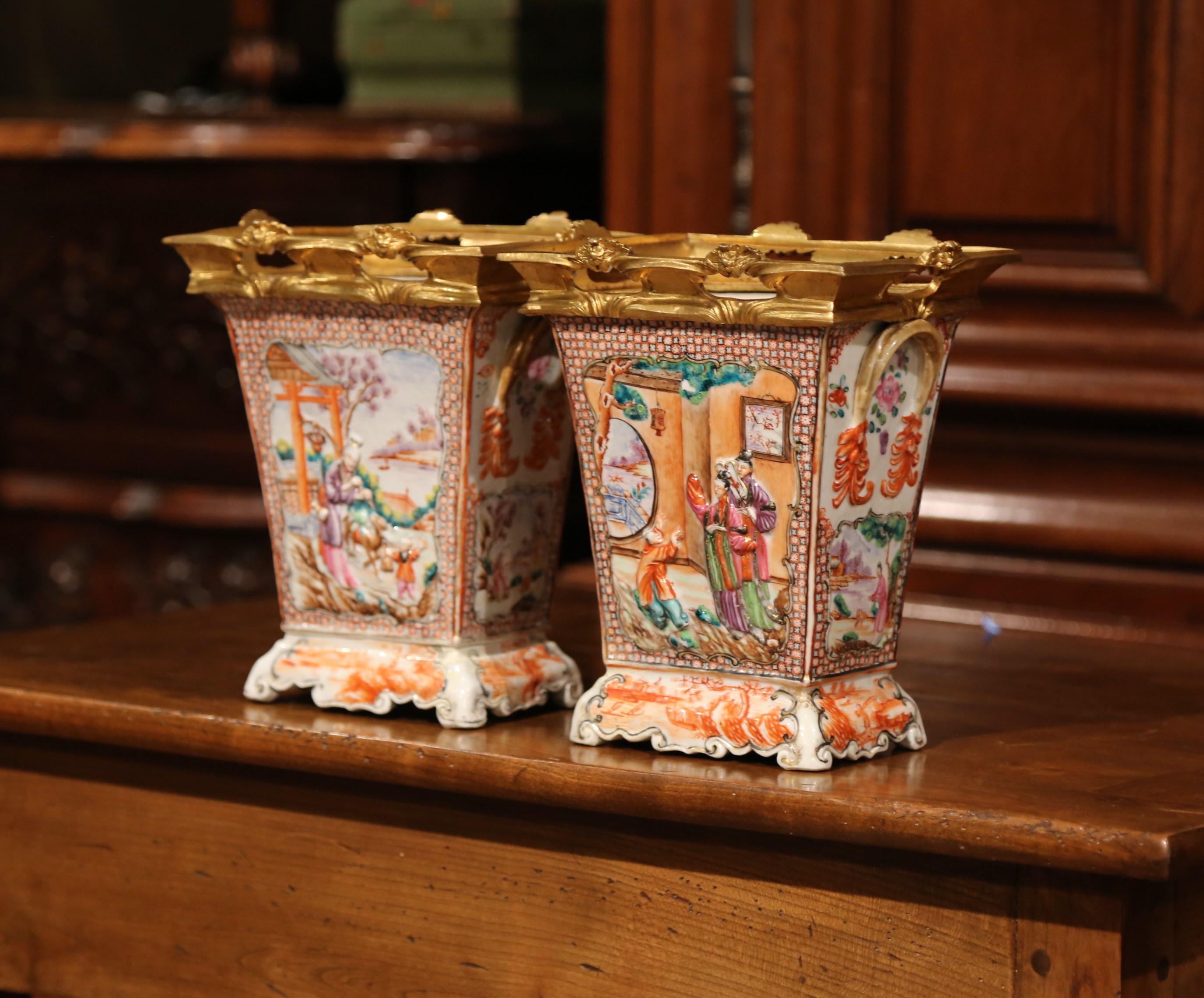 Decorate your living room mantle or entryway console with this pair of 19th century French porcelain and gilt bronze vases. Crafted in France circa 1880, the porcelain pots are embellished with high-relief decoration, and feature intricate, gilt
