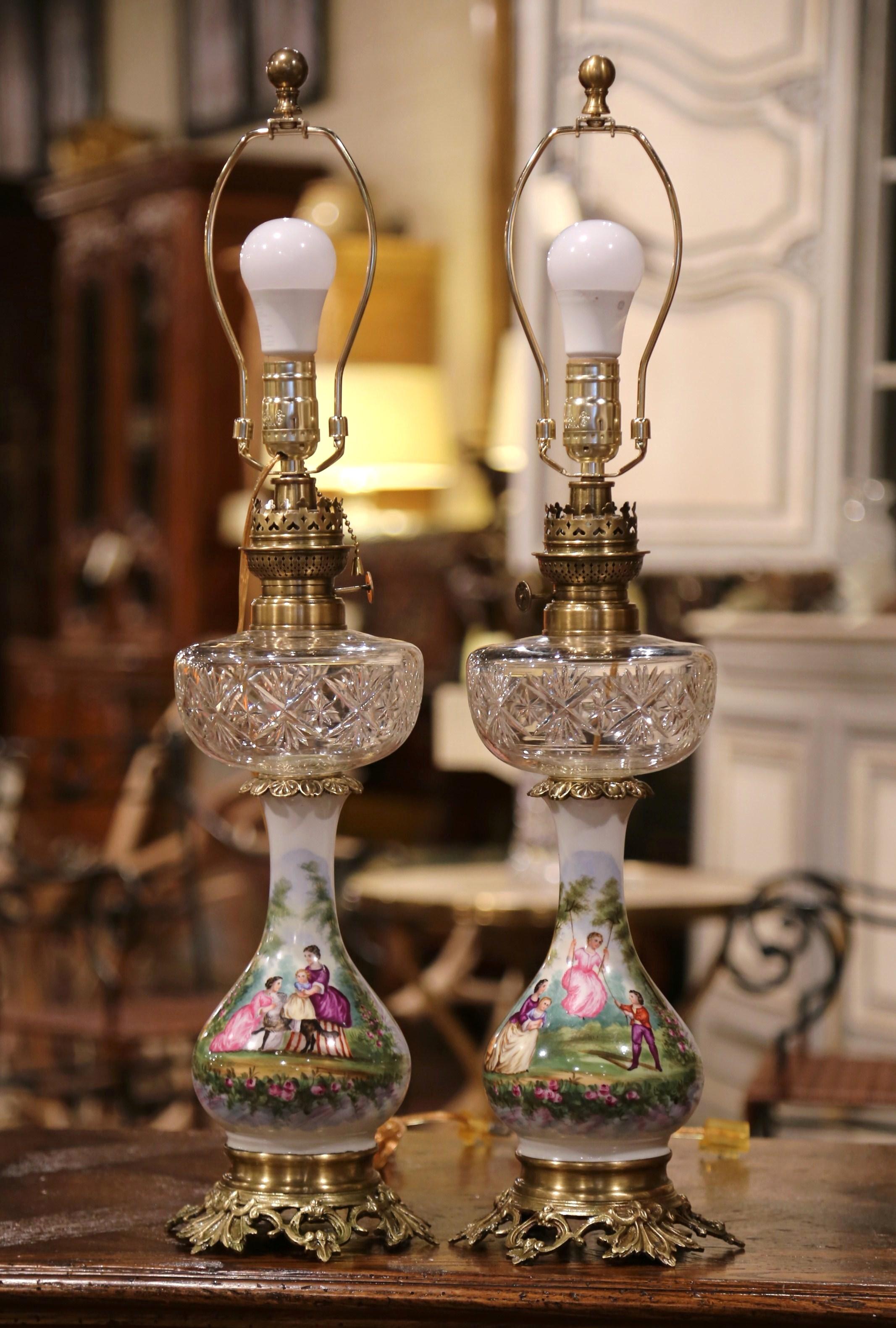 This elegant pair of antique oil lamps made into table lights was crafted in France, circa 1880. The tall 
