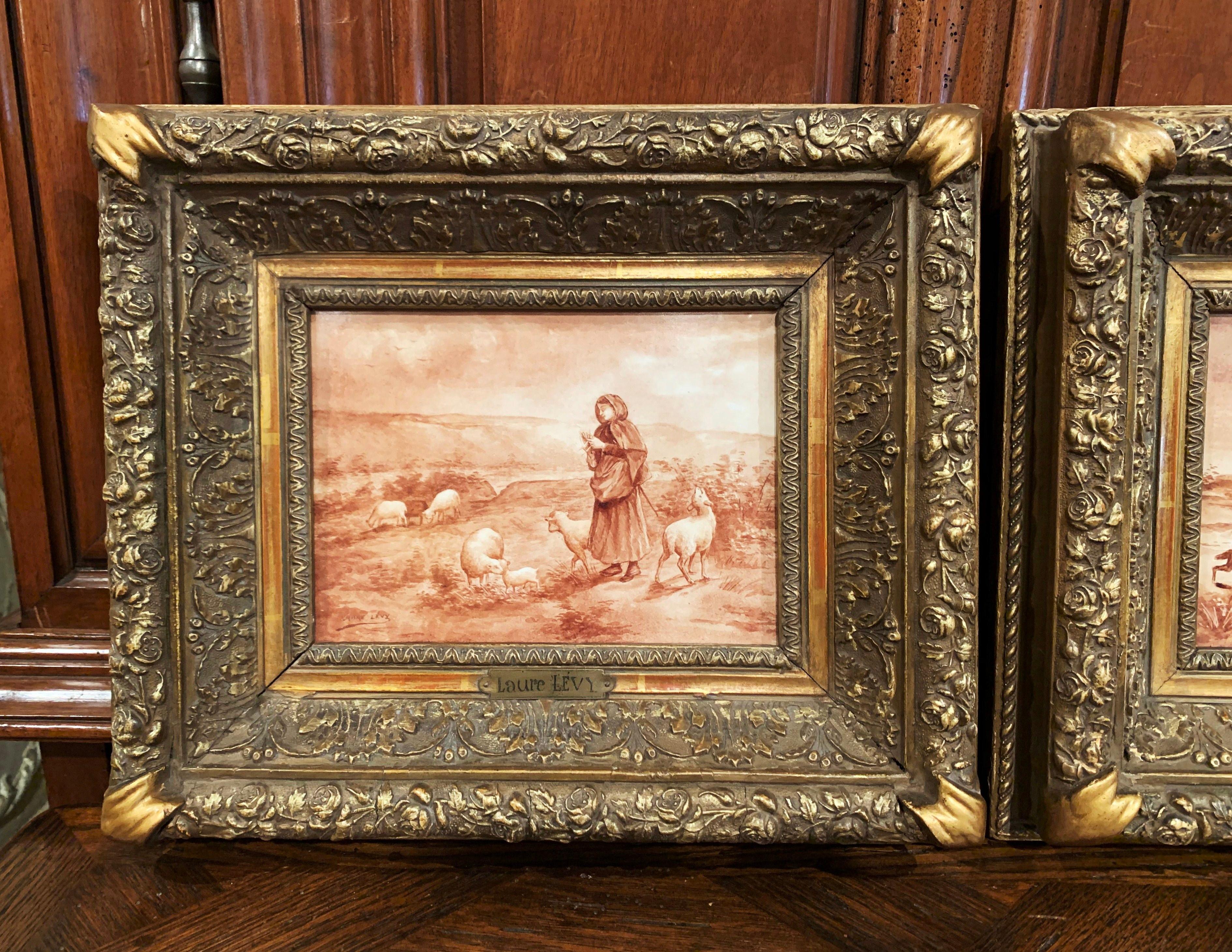 Crafted in France circa 1890, and set in the original carved giltwood frames, both antique porcelain plaques depict a hand painted pastoral scene in the beige and white palette. One painting features a shepherdess attending her sheep, the other