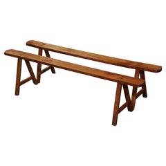 Pair of 19th Century French Provincial Carved Cherry Benches on Trestle Bases