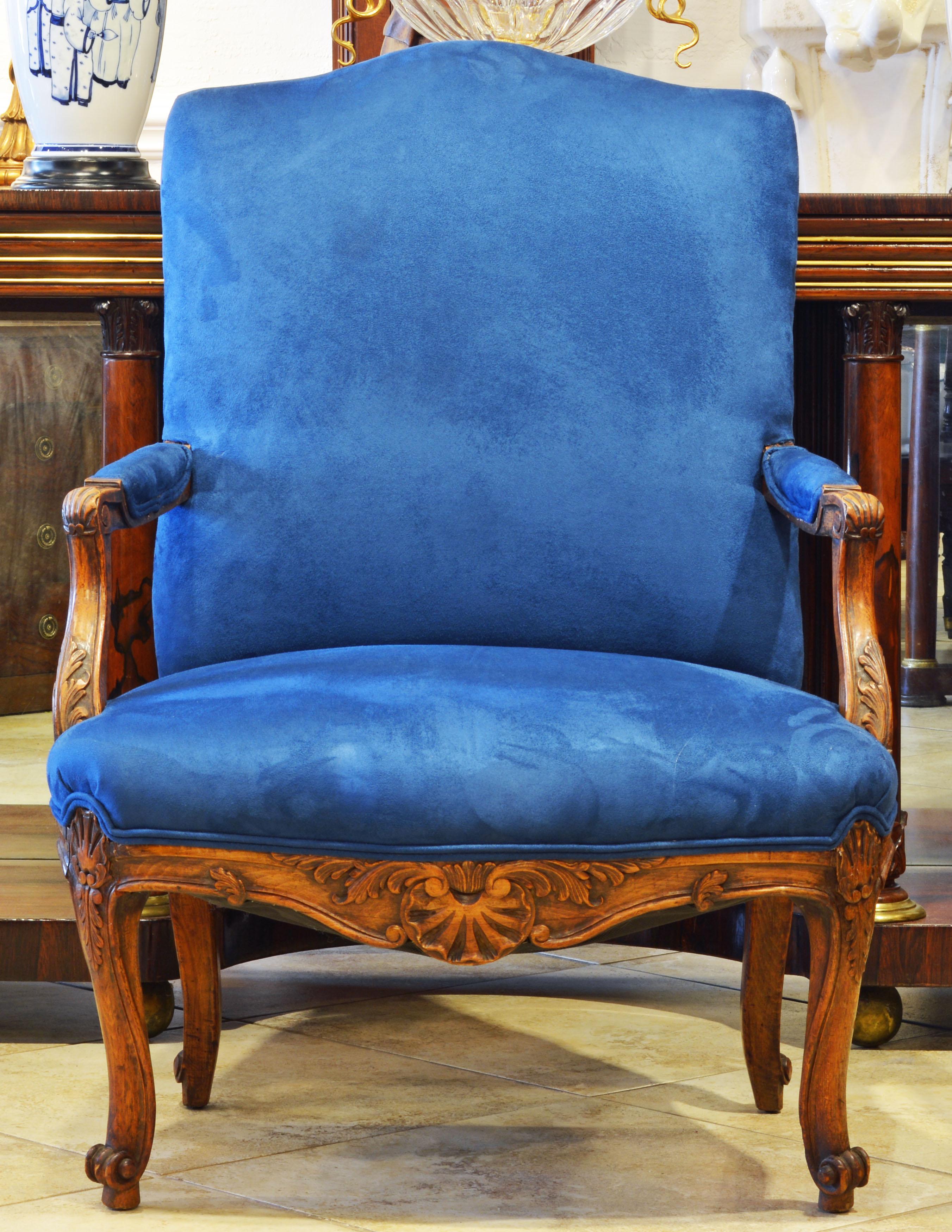 Of generous proportions these 19th century French Provincial armchairs feature carved armrests, elaborately carved and shaped aprons and carved cabriole legs all fashioned in the style of Louis XV. They are recently reupholstered and covered in an