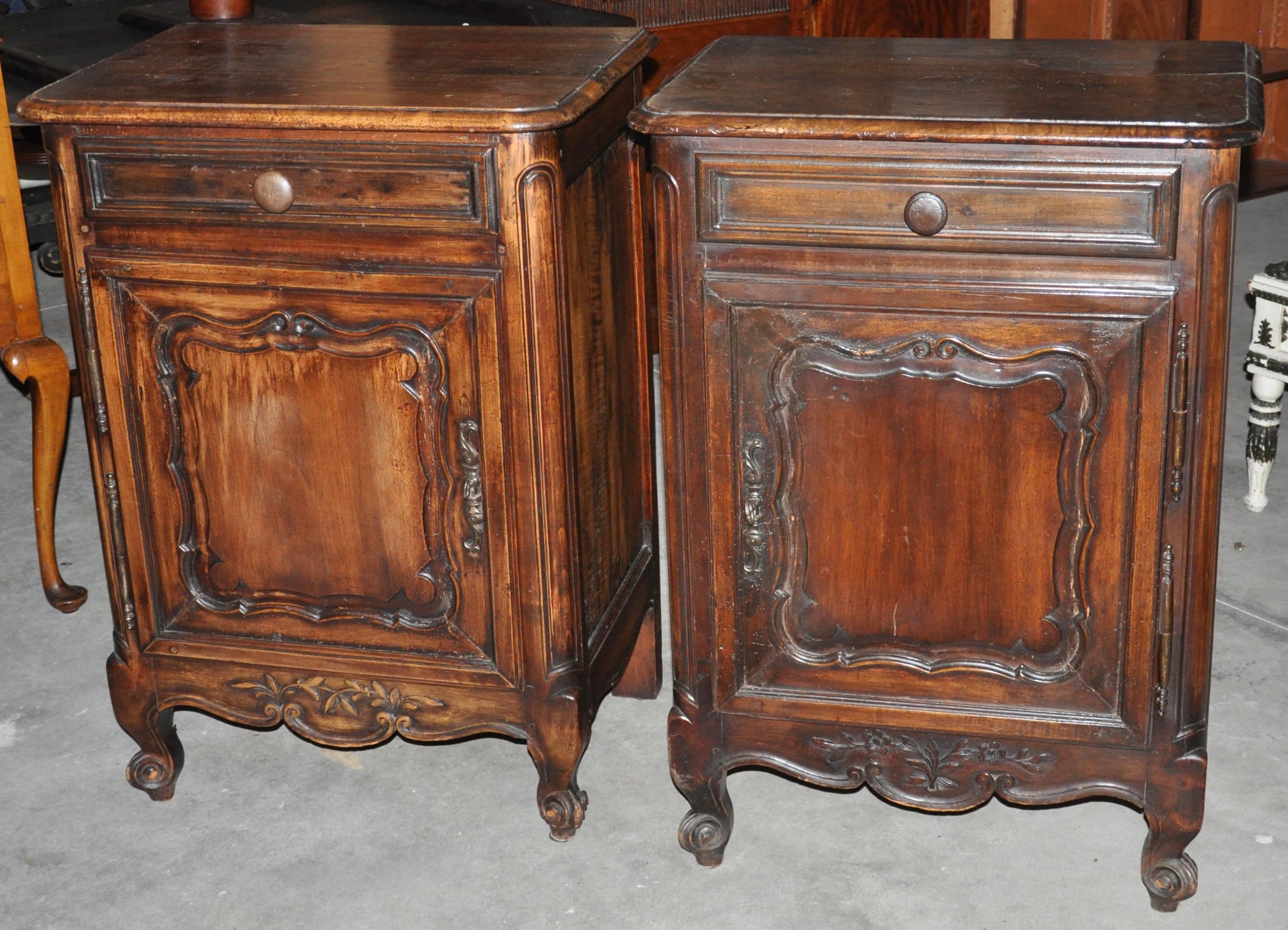 Pair of Louis XV style French Provincial side cabinets. Each with bottom door and one drawer. Walnut and fruitwood. Molded carved framed panel. Original finish. Cabriole legs. Great patina.