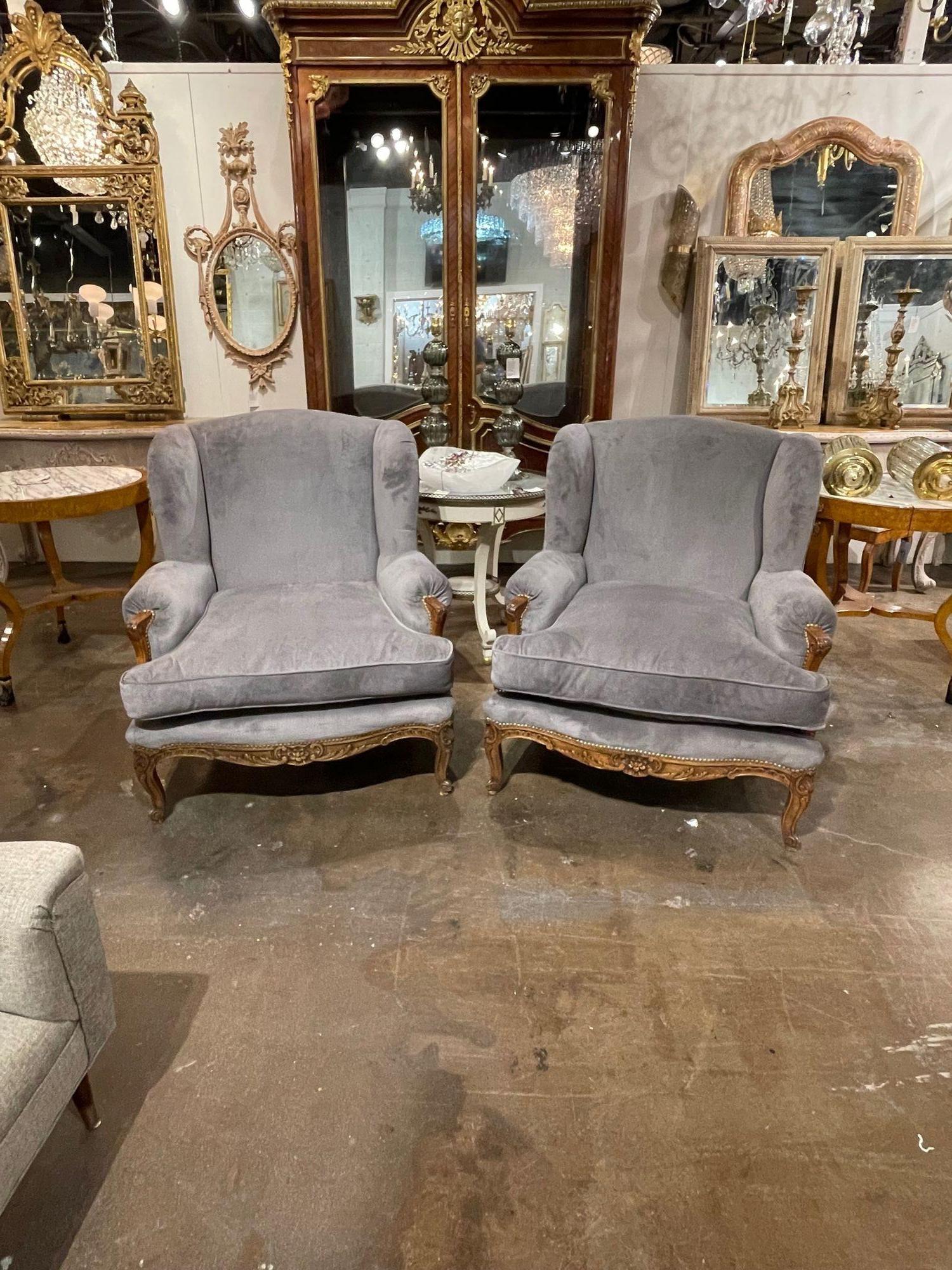 Gorgeous pair of 19th century French Provincial style Bergeres. Upholstered in a beautiful grey fabric. A very elegant pair that creates a very upscale look!!