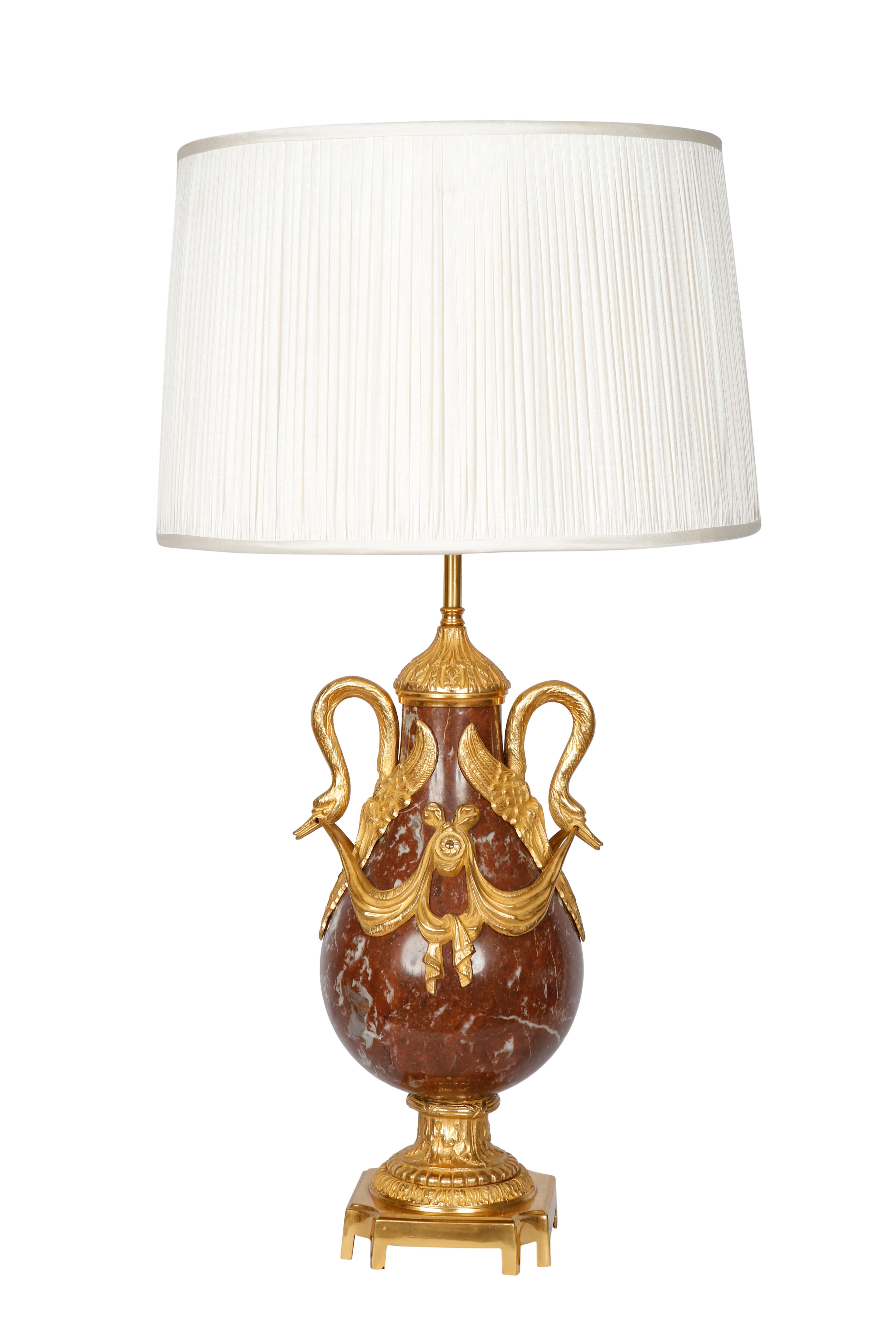 Crafted in France circa 1880, each cassolette is made of carved red marble and has a bronze base and decorative bronze mounts. The cassolettes have been converted into table lamps and both have custom pleated white shades. The lamps are in excellent