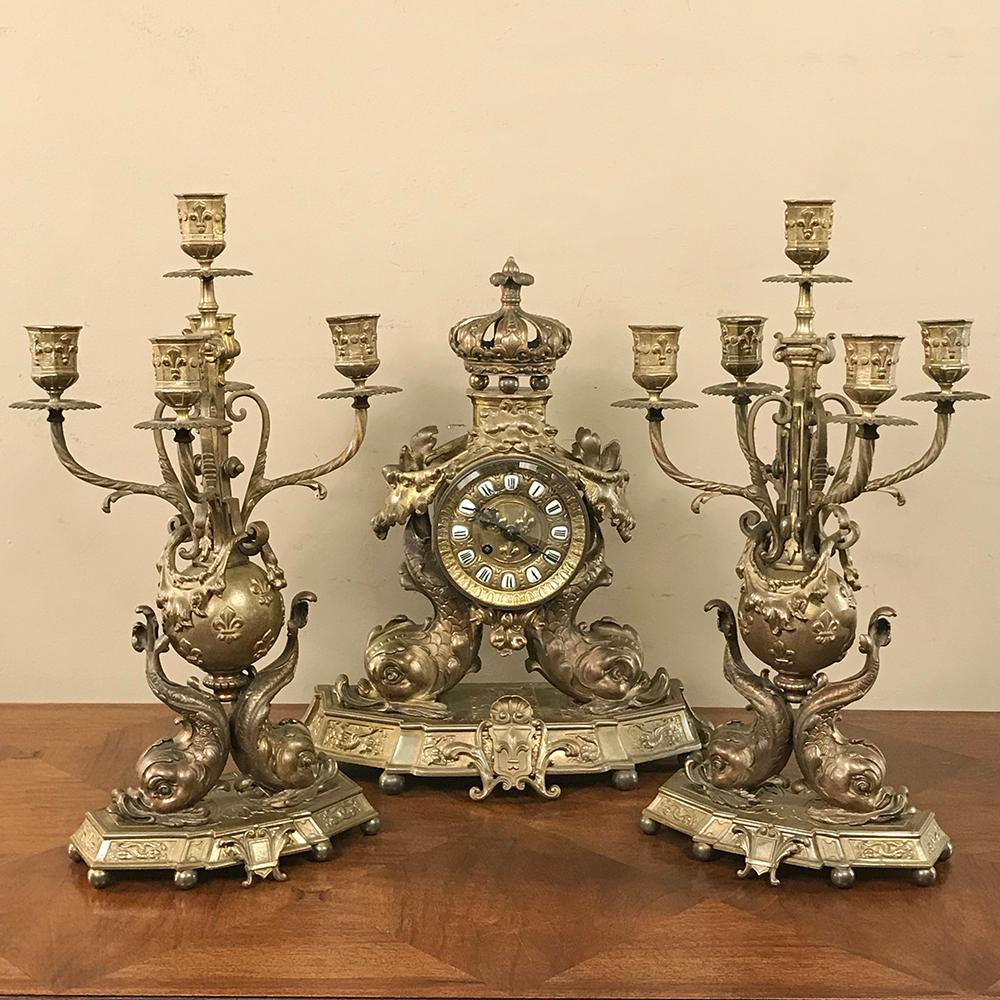 Pair of 19th century French Renaissance Dolphin Candleabra represent an extraordinarily elaborate artistic work in cast bronze, created at the peak of the Belle Epoque. Such candelabra could accompany a matching mantel clock pictured in the related