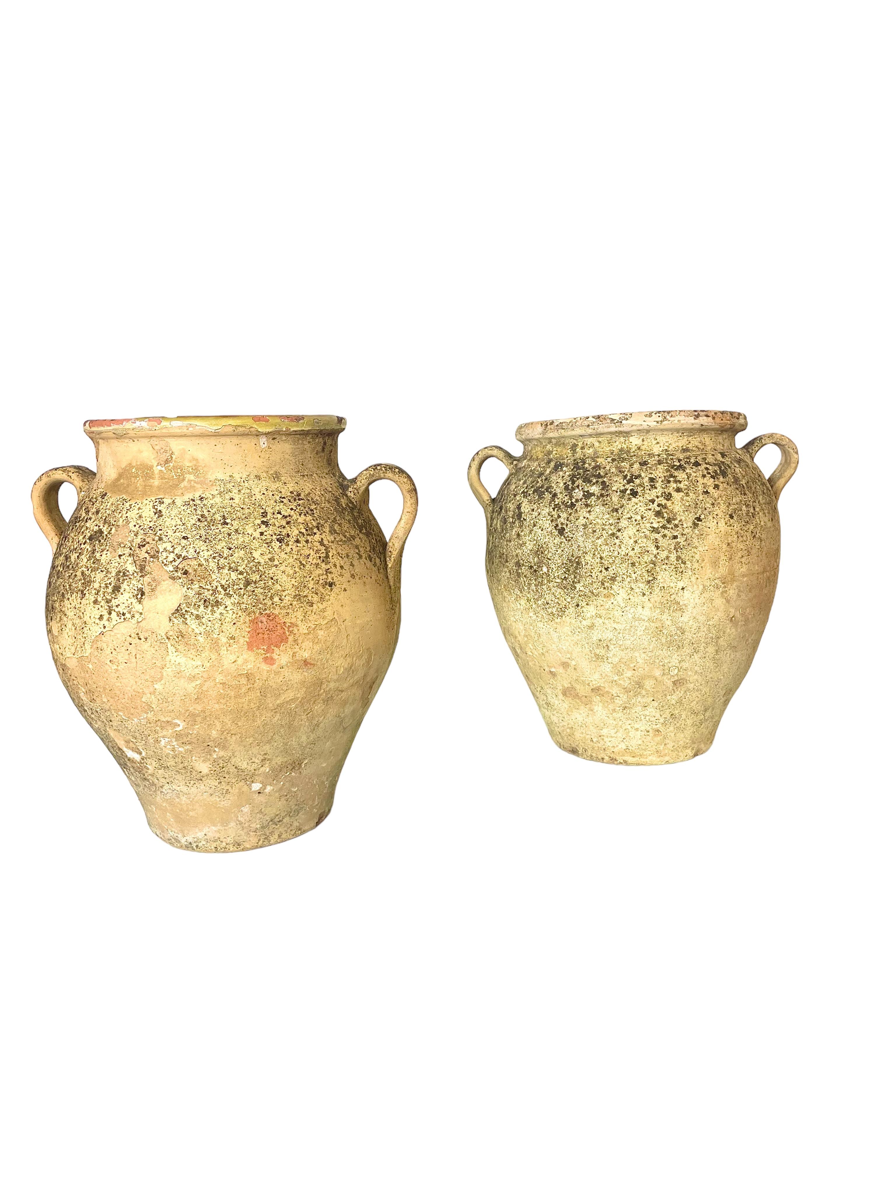 A very attractive pair of provencial French Confit Pots, each with two side handles, and glazed internally. Light in colour, their exterior surfaces are beautifully aged, and full of character. Once used in a southern French kitchen for the