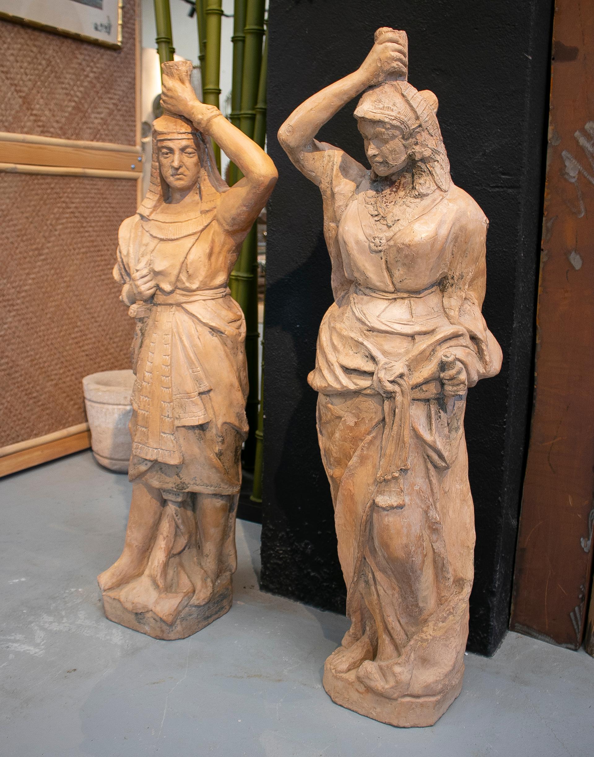 Pair of 19th century French terracotta Egyptian couple torcheres sculptures and standing lamps.
