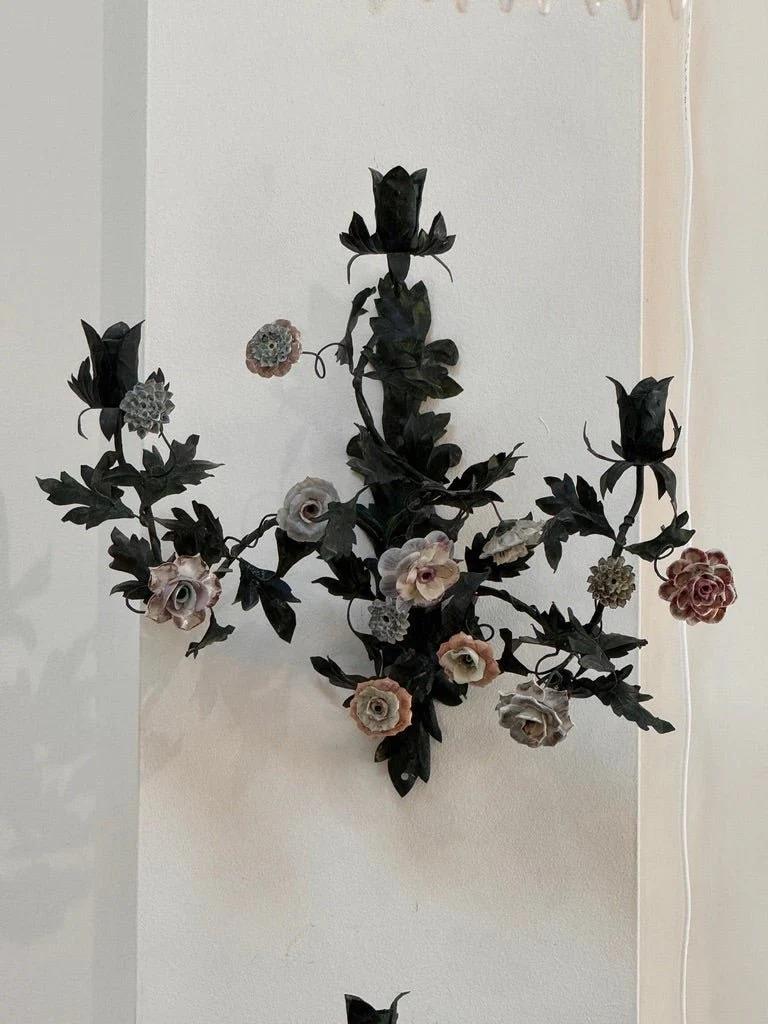 Pair of outstanding 19th Century French tole sconces, previously owned by Iris Apfel  having fine porcelain flowers, each having three candle holders. 


