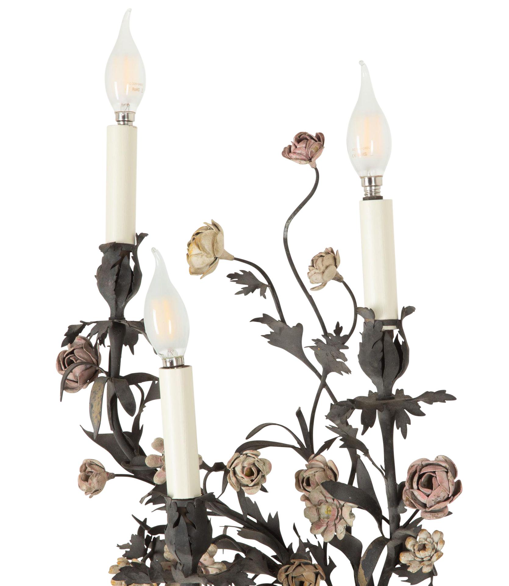 Exceptional pair of 19th Century French metal wall lights. 
The metal has been woven into a wire work basket frame, with porcelain flowers, decorator's piece and three arms. 
Rewired and PAT tested to UK standards.