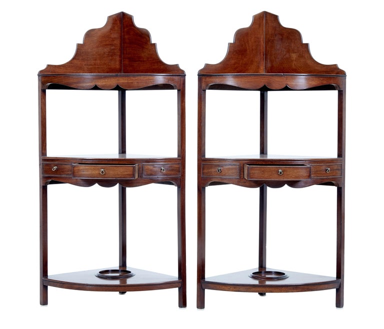 Pair of late Victorian mahogany corner washstands circa 1890.

Gallery top comprising of 3 tiers, second tier with 1 drawer and 2 dummies, bottom tier with bowl cradle. Minor repairs to gallery top.

Ideal for use in the corner of a bedroom or