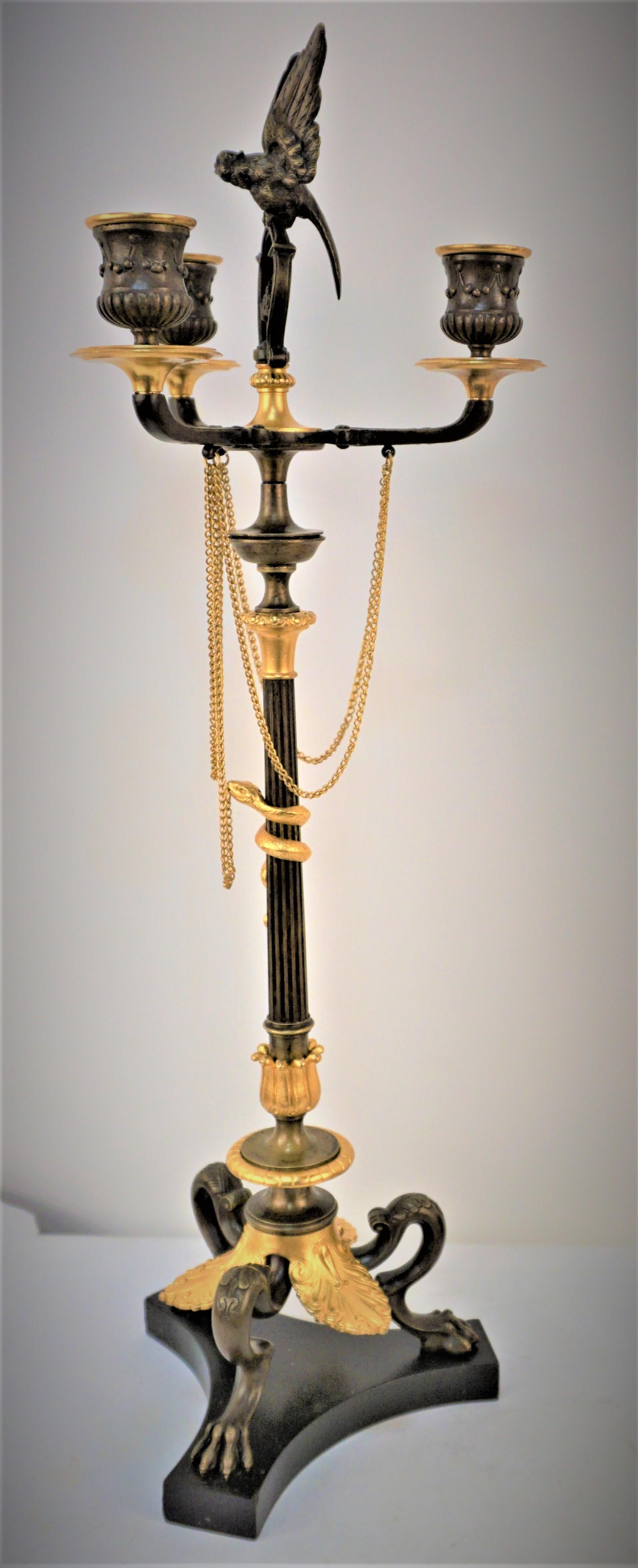 Pair of 19th century in gilt and oxidized bronze with bird finial and snake which is Sambol fertility, a creative life force, rebirth or guardian.