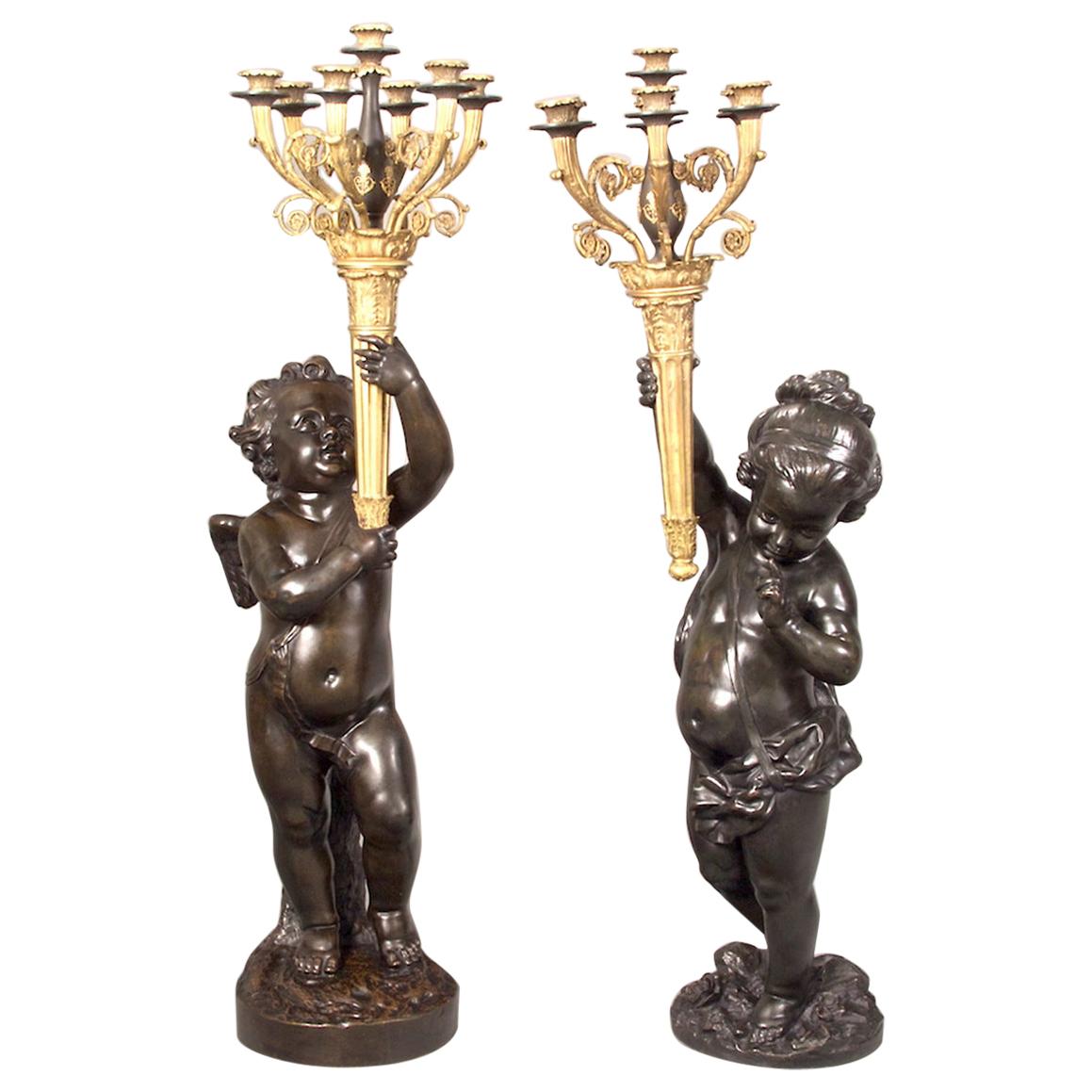 A pair of important monumental gilt and patinated bronze Putti Torchères and marble pedestals.
 
Origin: France 
Date: circa 1890 
Dimension: 48 in. x 11 in. (Figures); 42 3/4 in. x 13 in. (Pedestal)