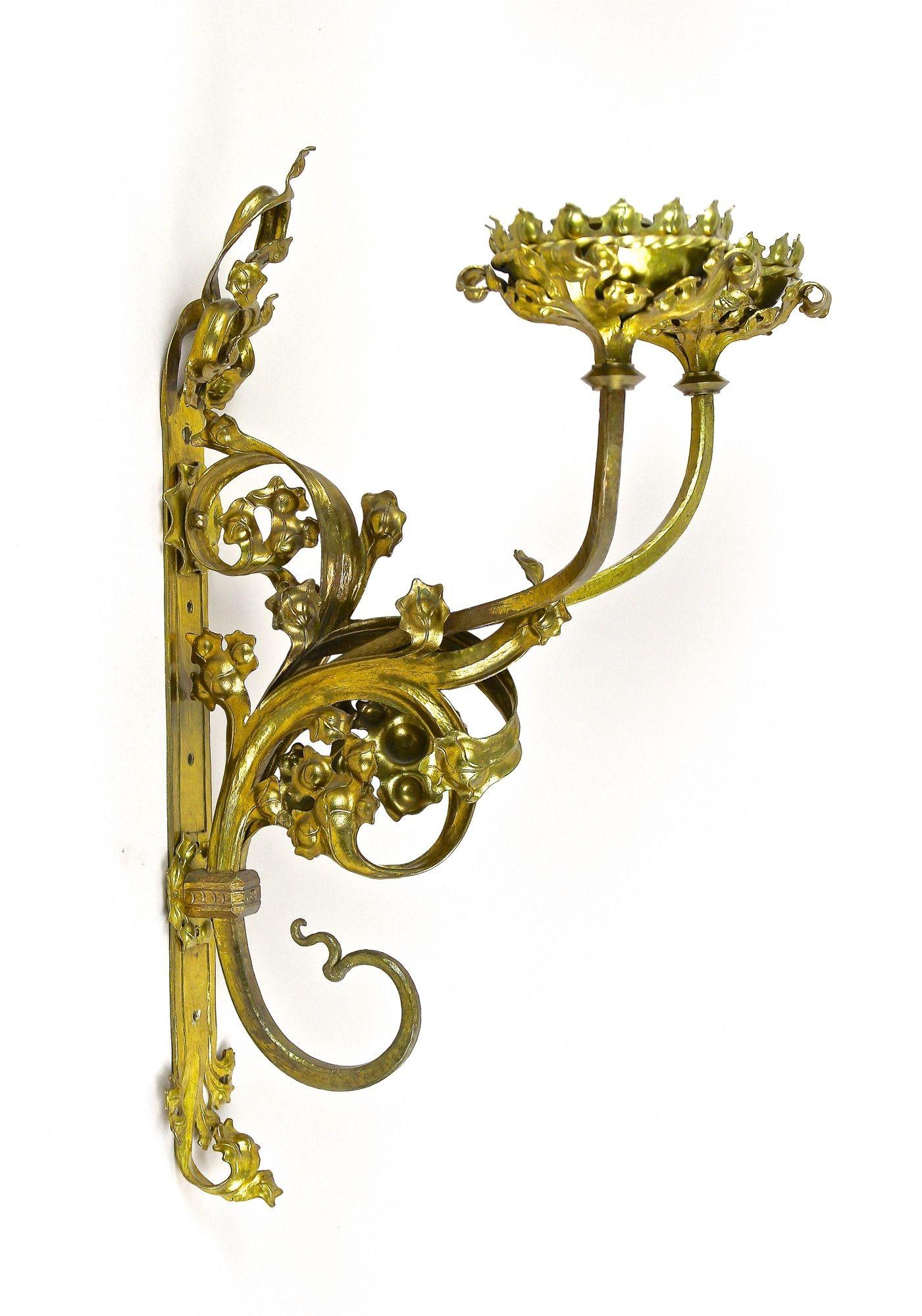 Remarkable pair of handforged 19th century candle wall sconces from the period around 1890 in Austria. Artfully crafted out of fine brass, these large candle sconces impress with their exceptional quality and design. Made in the late 19th century,