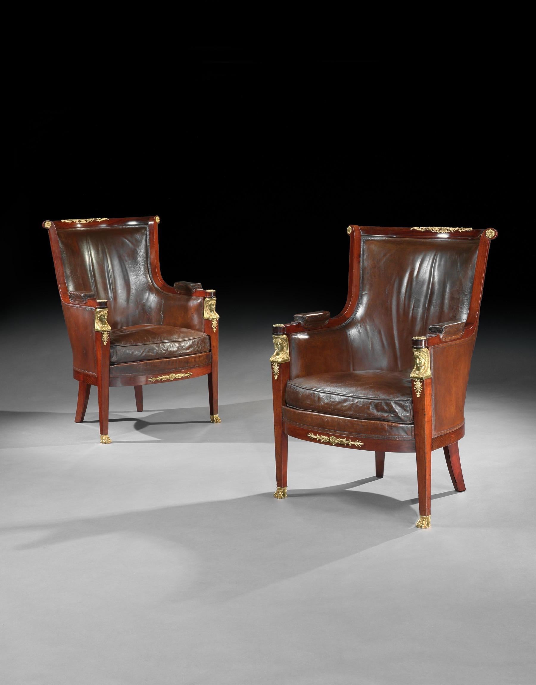A very fine pair of late 19th century French Empire style mahogany library bergeres, gilt bronze mounted retaining the original Moroccan leather upholstery, attributed to Maison Lalande.

French, circa 1890-1900.

The curved top-rails with