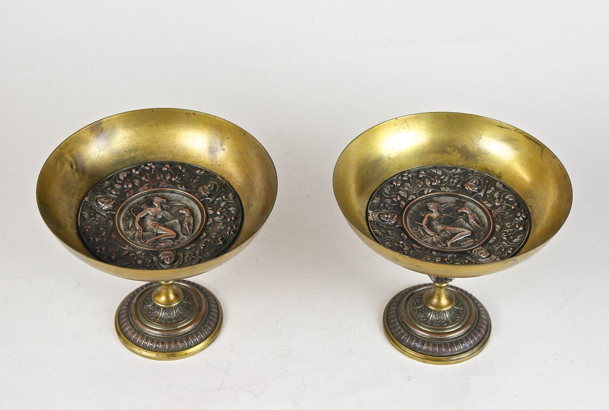 Extraordinary pair of 19th century fire gilt bronze centerpieces from around 1880 in Austria. These elaborately made centerpieces were shaped like wide goblets or bowls and impress with gorgeous designed bases adorned by artfully worked middle parts