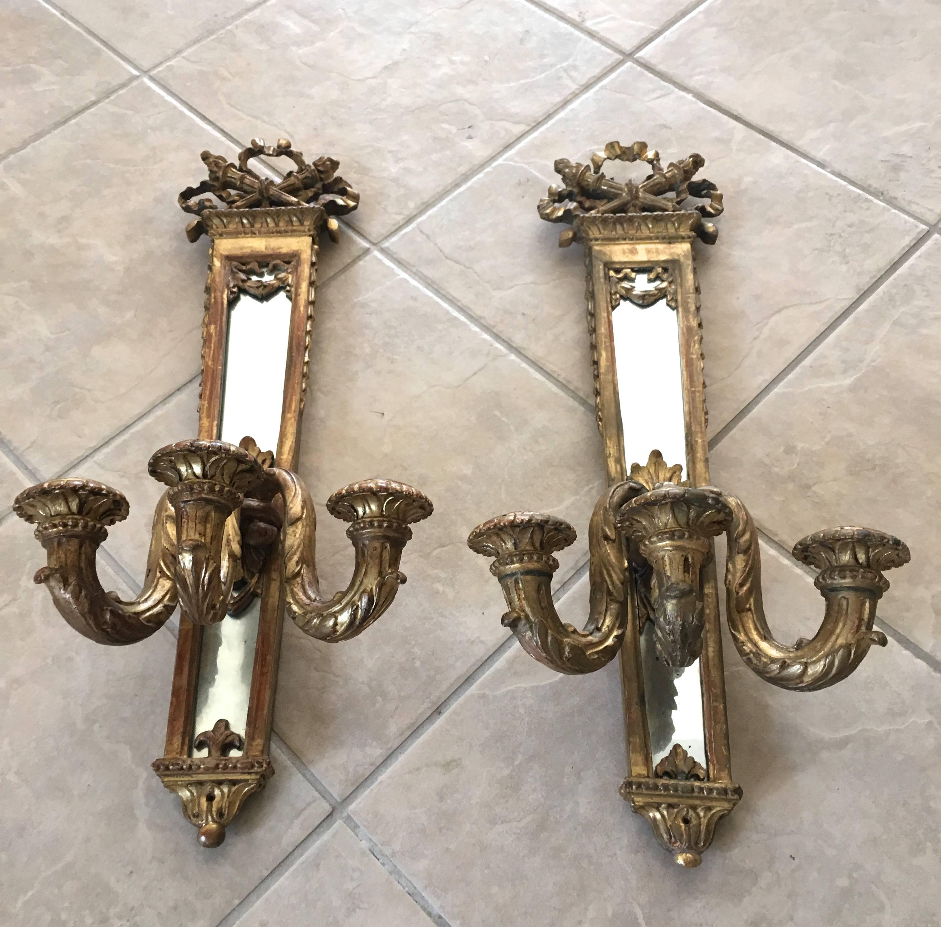 Pair of 19th century water gilt Louis XVI style three candle mirrored wall sconces (not electrified).