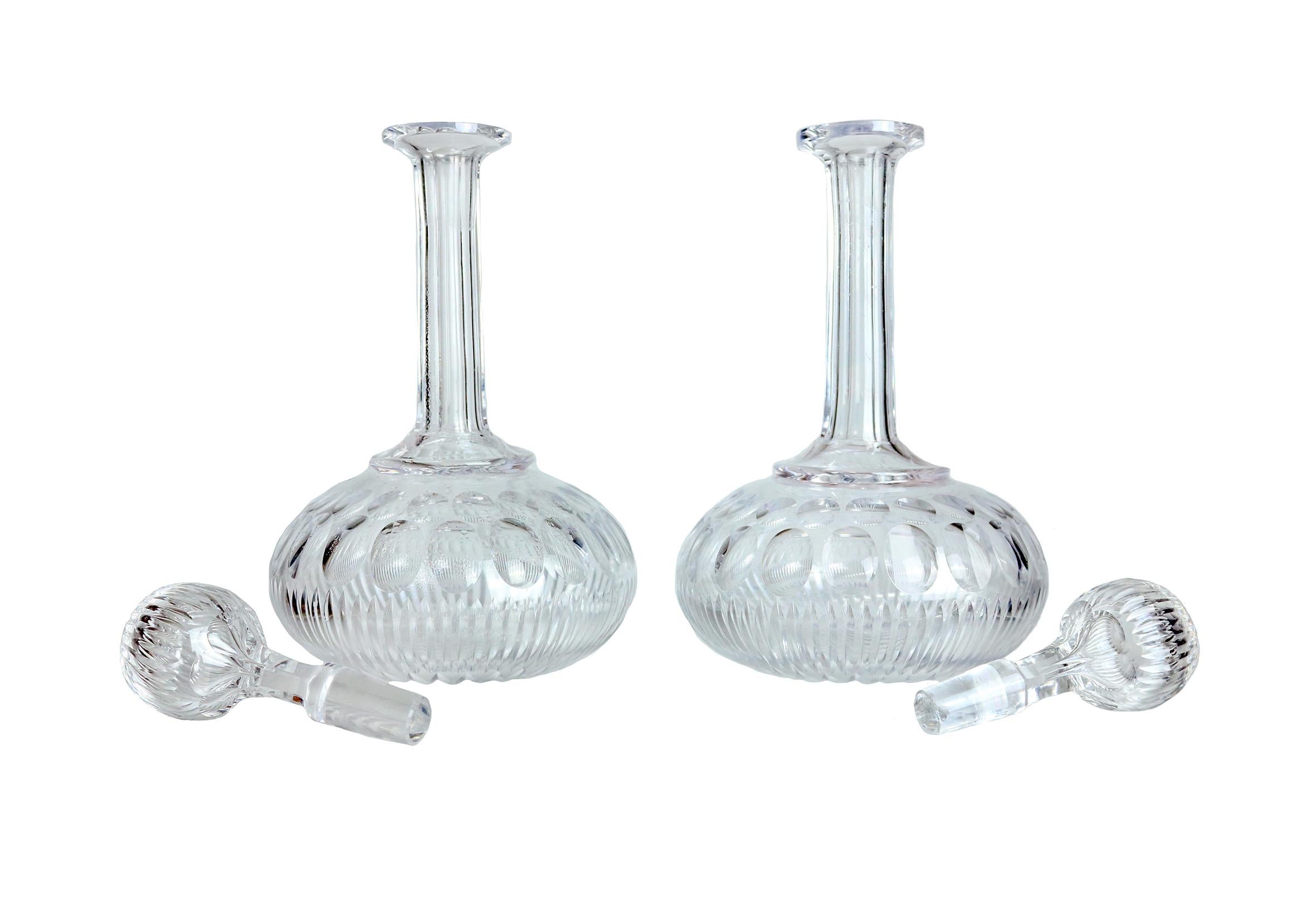 A stunning pair of 19th century glass decanters with original stoppers. Fantastic globe shape and intricate pattern.