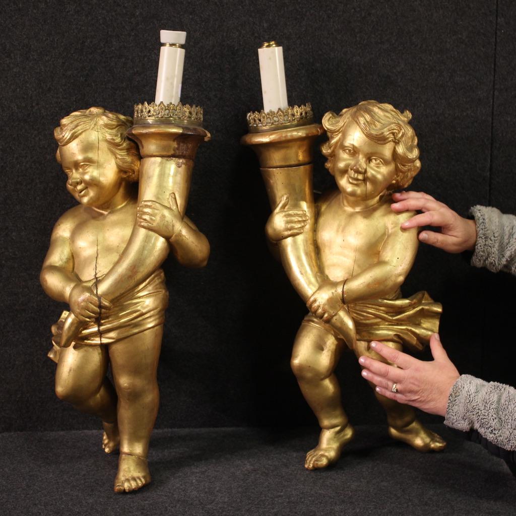 Pair of Italian sculptures from the first half of the 19th century. Finely carved and gilded wooden works depicting cherubs with cornucopia, probably born as candle holders. Excellent quality sculptures, right and left, in mirrored position. Objects