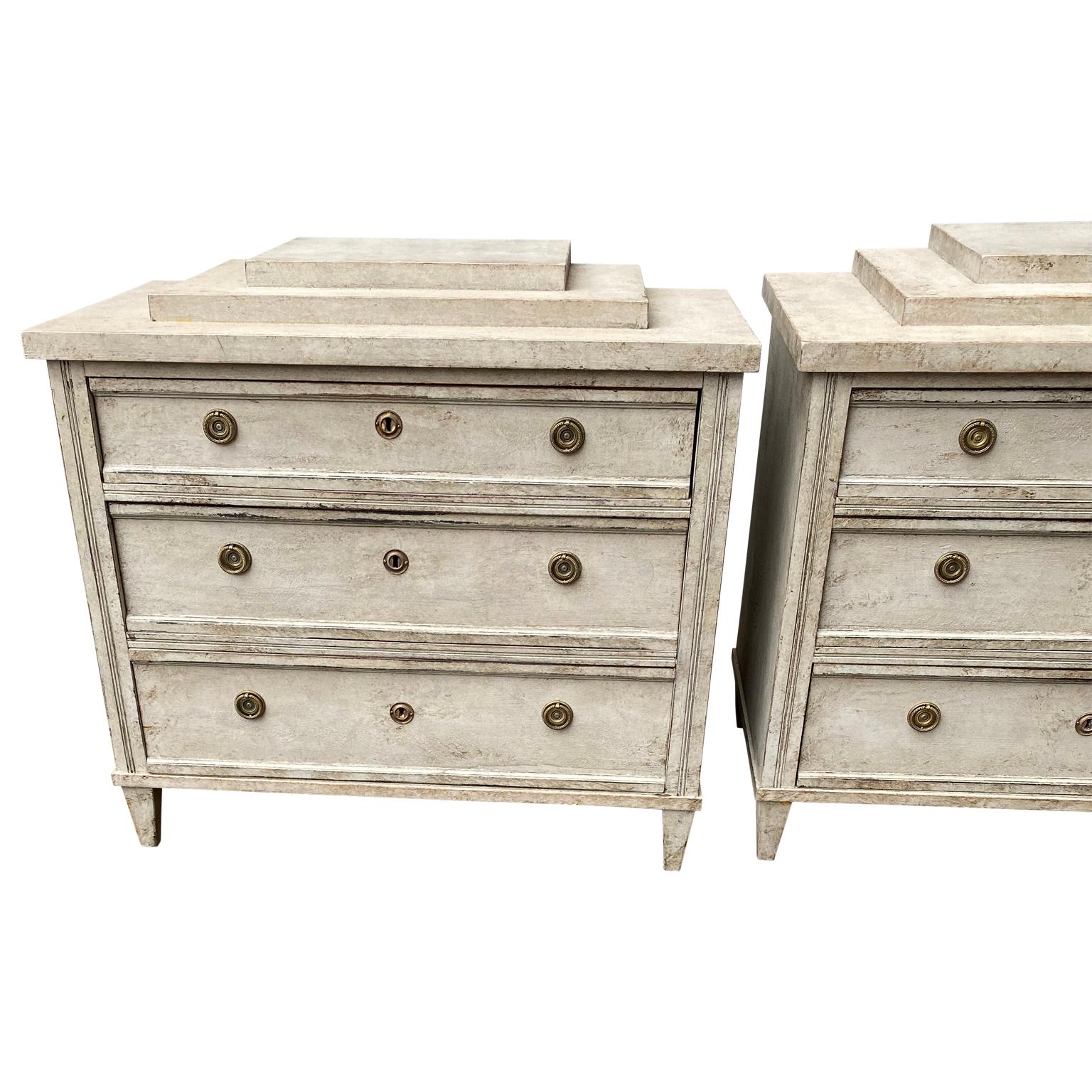 Pair of Gustavian style chest of drawers with pedestal top surface, also referred to as 