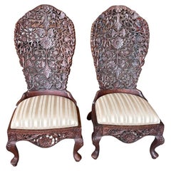 Pair of 19th Century Hand Carved Burmese Nursing Chairs with Silk Covered Seats