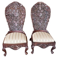 Pair of 19th Century Hand Carved Burmese Nursing Chairs with Silk Covered Seats