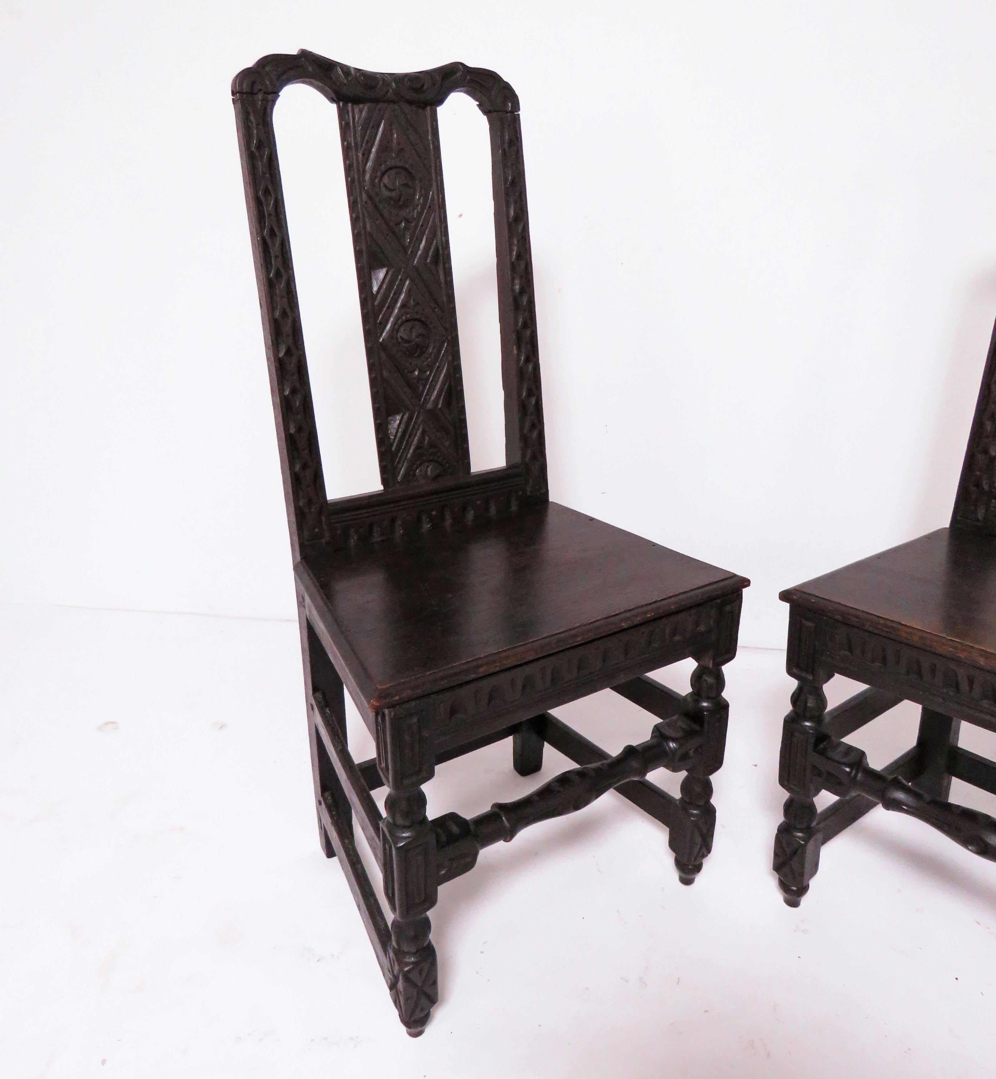 A pair of tastefully carved Flemish side chairs in ebonized walnut, dating to the second quarter of the 19th century.

Due to their handmade nature, there are very slight differences in their overall measurements. One measures 18.5