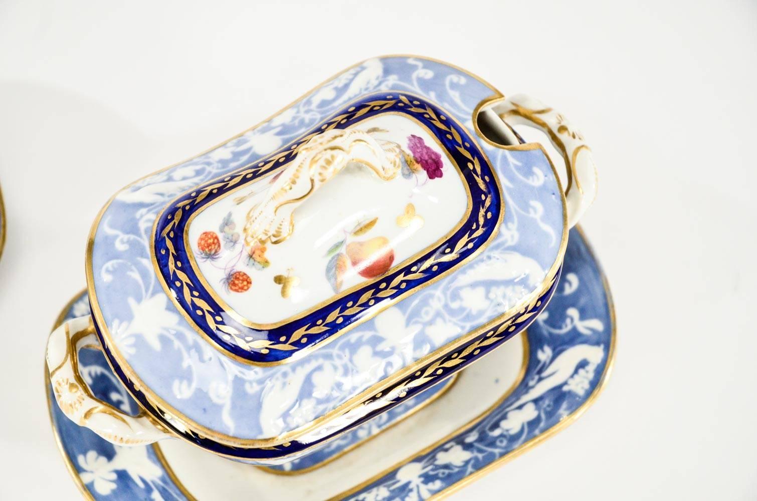 This is a special pair of 19th C, Spode sauce tureens with matching attached underplates and handles. The raised molded relief  depicting pheasants and the addition of hand painted polychrome enamel fruit makes them more unique and the condition is