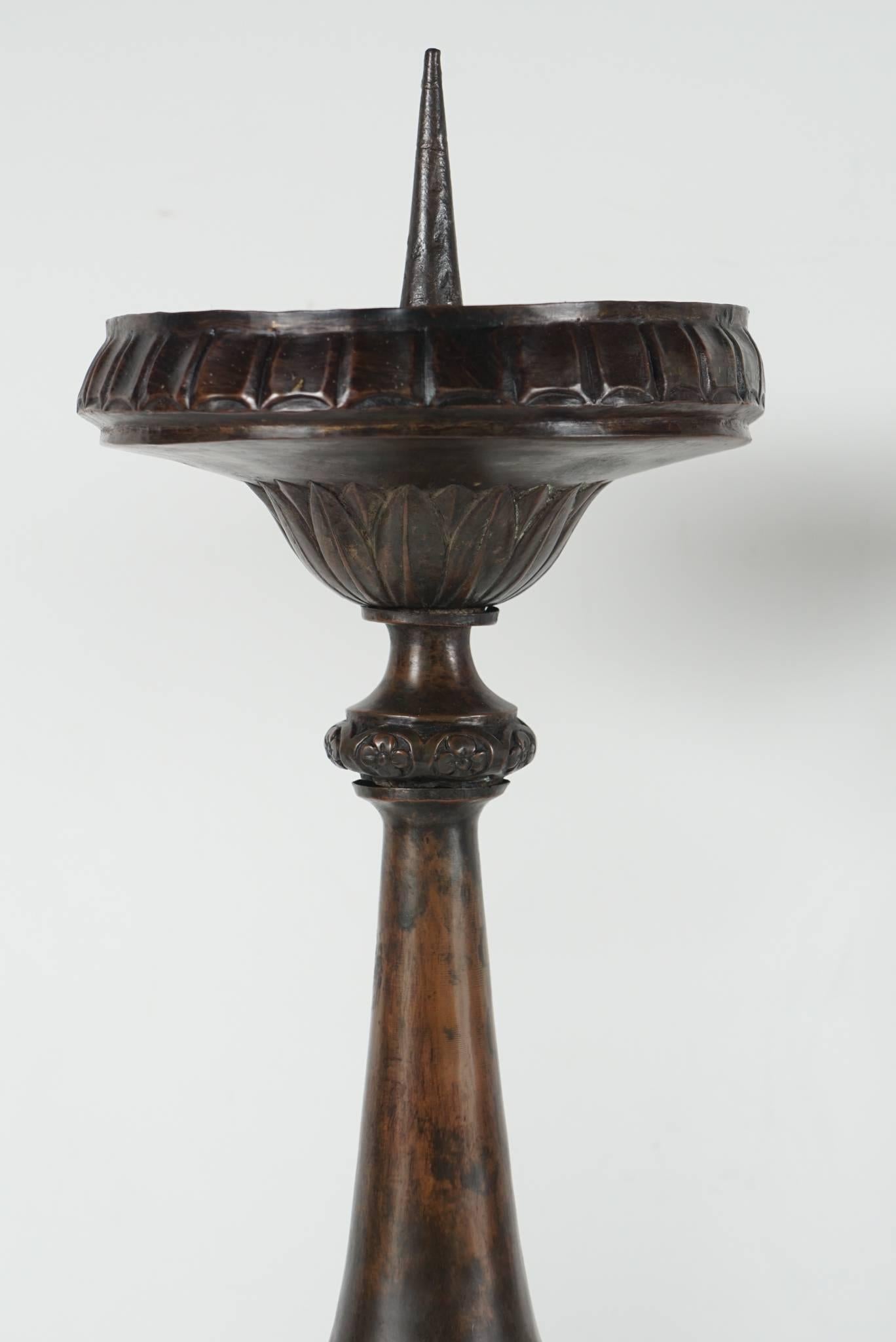 This pair of large and impressive pricket candlesticks was made in the Baroque style, circa 1850. Cast as sectioned hollow pieces and fitted over a wooden core the design is built up one on top of the other and then applied repousse decorative