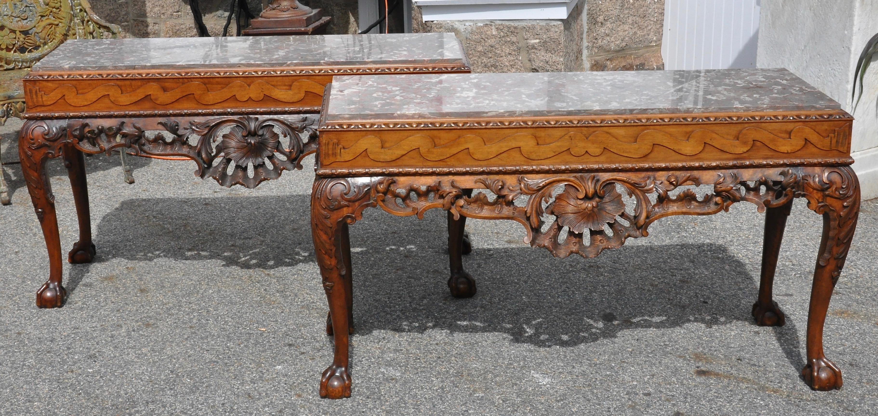 Pair of Irish walnut marble top console tables in the Georgian style

Fine walnut Chippendale George II ball and claw foot console tables. Frieze with running dog motif, exquisite Rococo carving. Four cabriole legs. Original finish. Fossilized