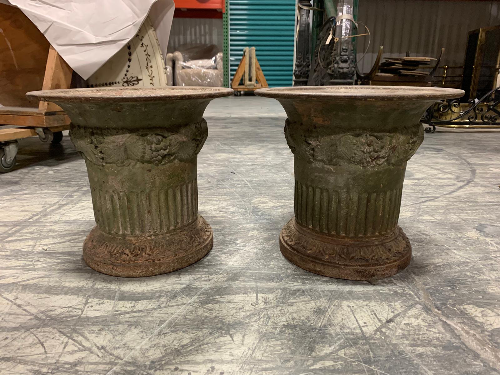 Pair of 19th century iron Directoire garden planters fluted with leaf detail.